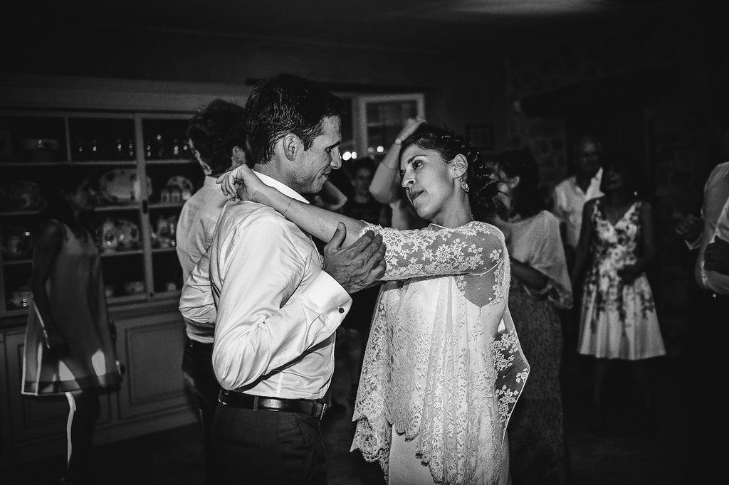 Bride and groom sharing intimate dance together at wedding reception in black and white.
