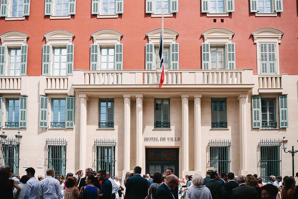 Guests gather outside the Hotel de Ville in Nice, France for a wedding ceremony.