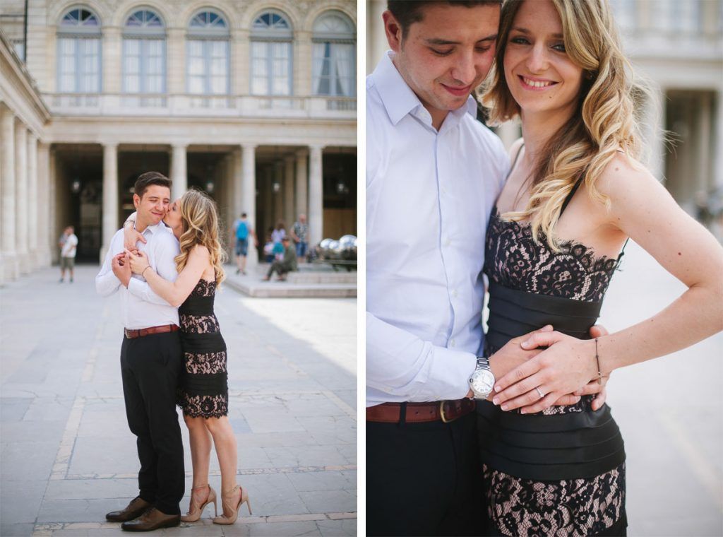Couple embracing and posing together in a sunlit courtyard with classical architecture in the background.