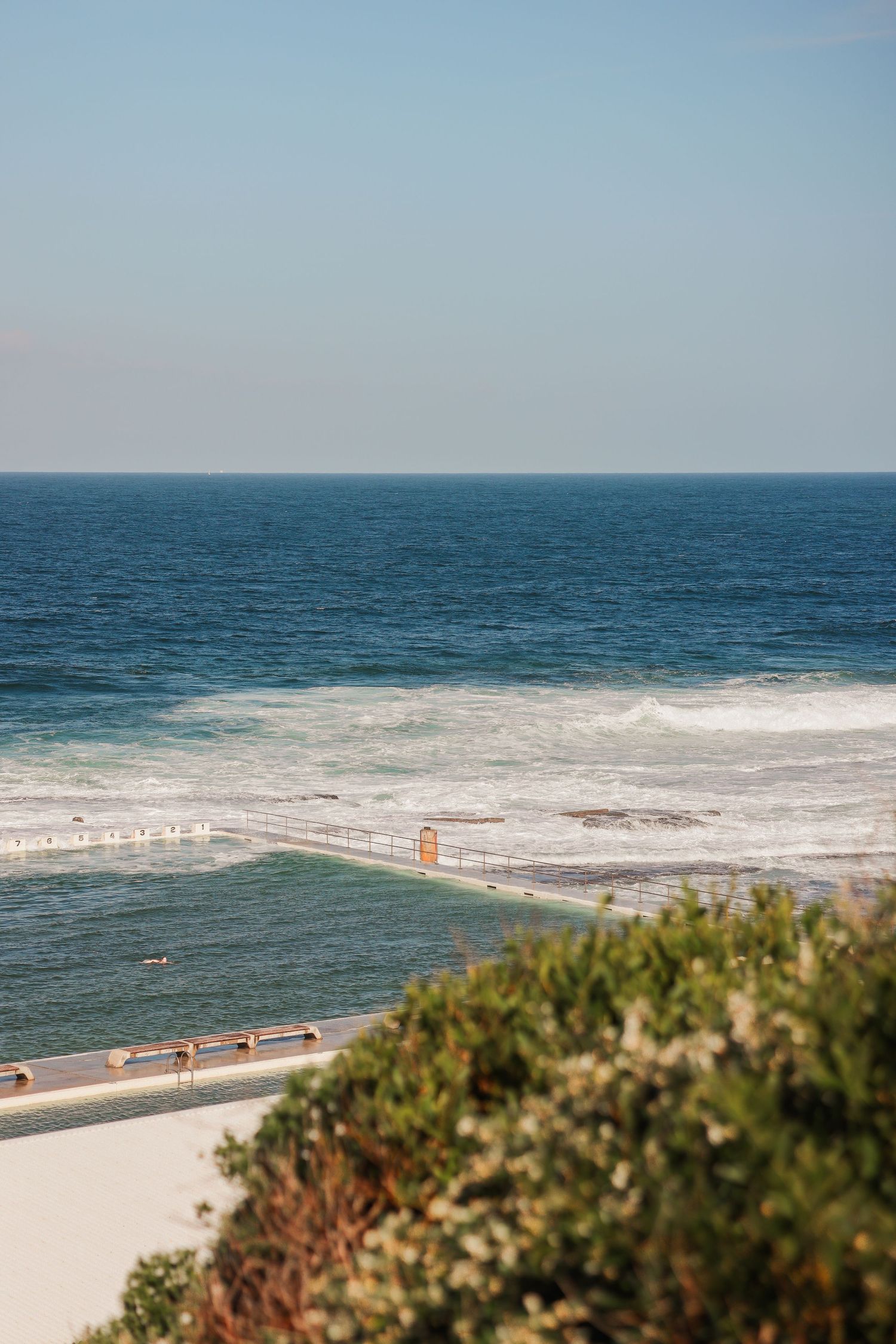 Ocean waves breaking at Bondi Beach with turquoise water and white sand coastline.