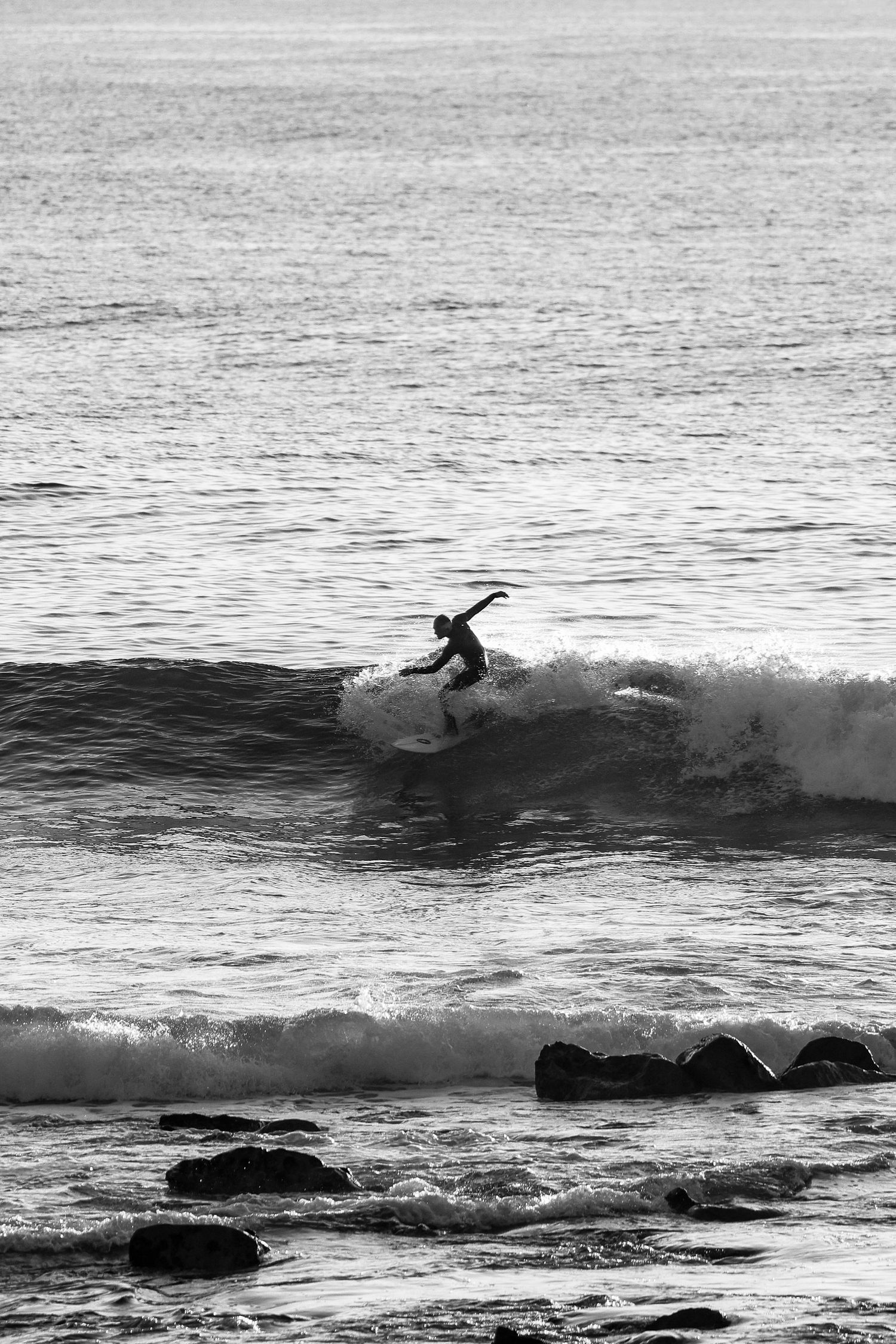 Surfer riding a clean wave break.