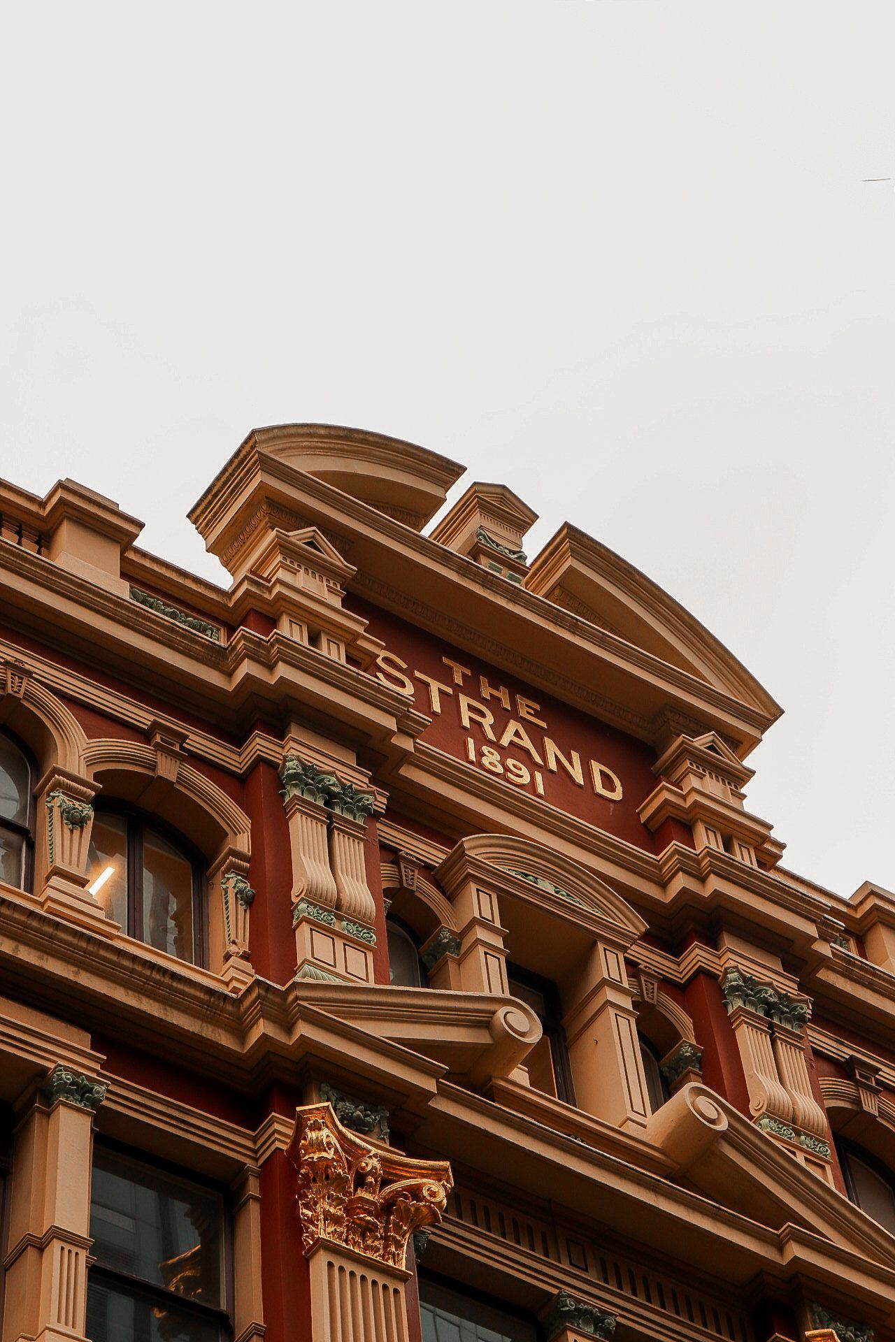 Ornate Victorian-style architecture with detailed columns and moldings on a historic building facade.