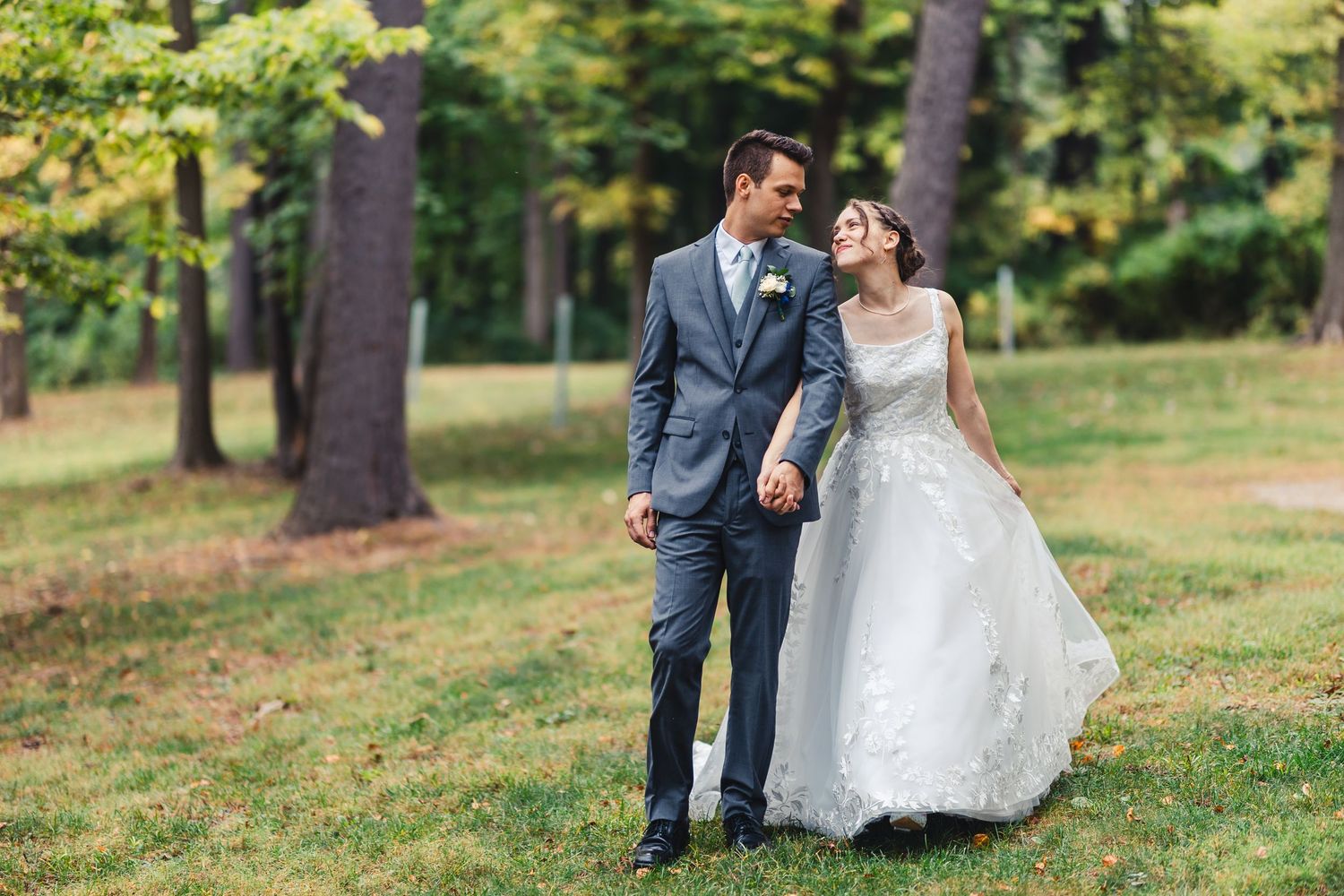 Bride and groom walking together during outdoor wedding portrait in Palm Beach Gardens