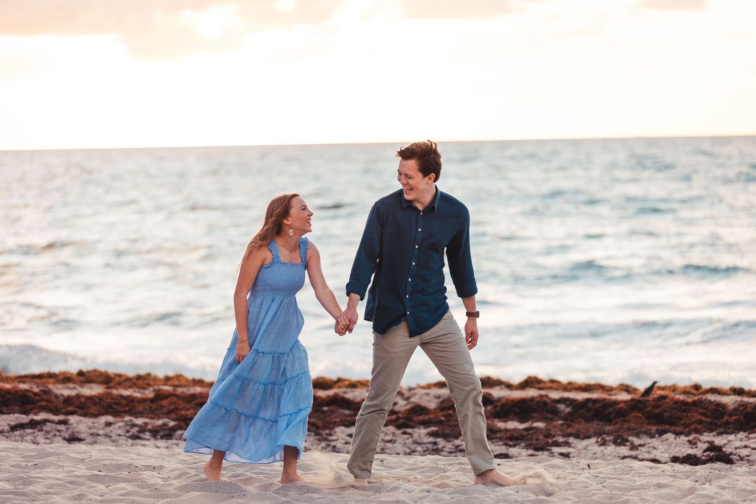 Couple holding hands during beach engagement session in Palm Beach Gardens