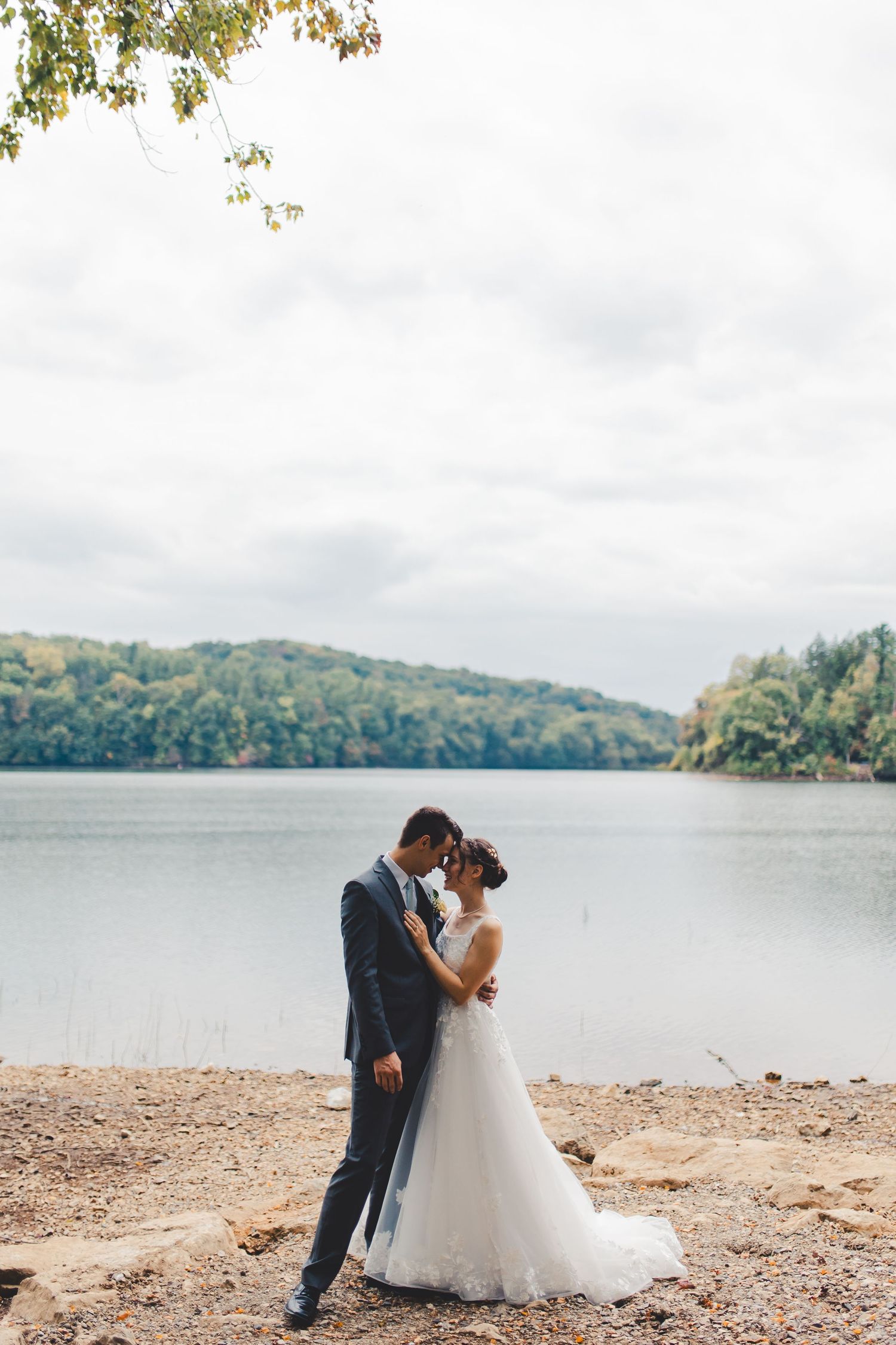Bride and groom embracing by water during wedding portrait in Palm Beach Gardens