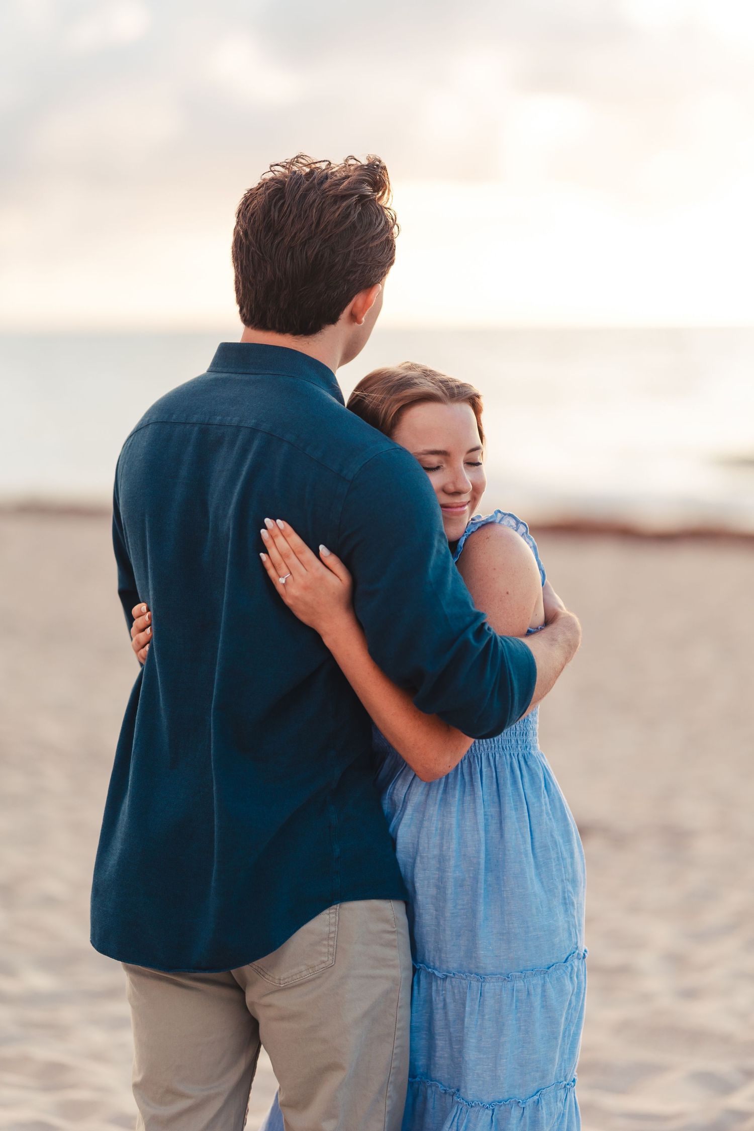 Couple embracing on the beach at sunset during West Palm Beach Florida engagement session
