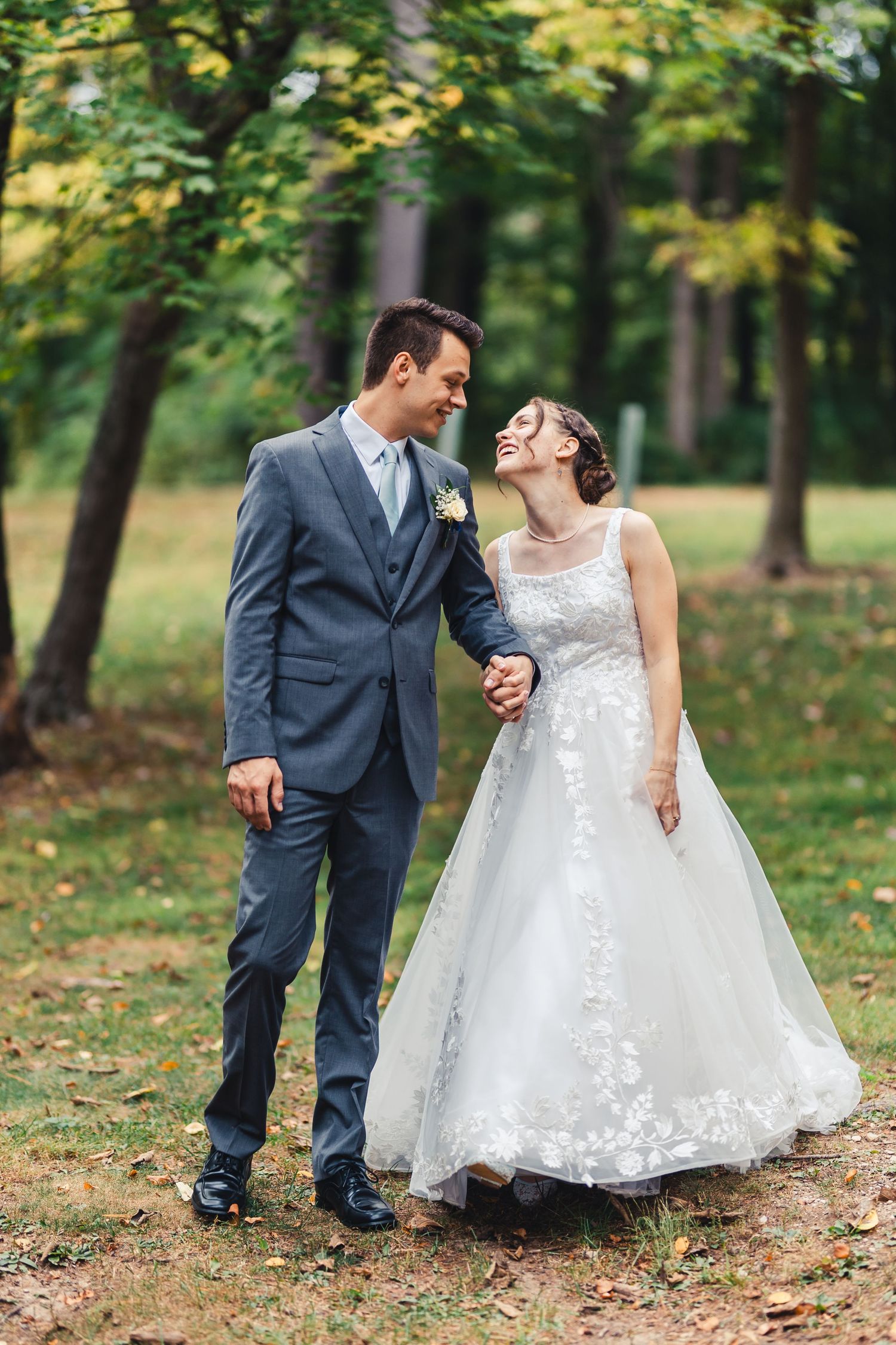 Bride and groom walking hand in hand during outdoor wedding portrait in Palm Beach Gardens