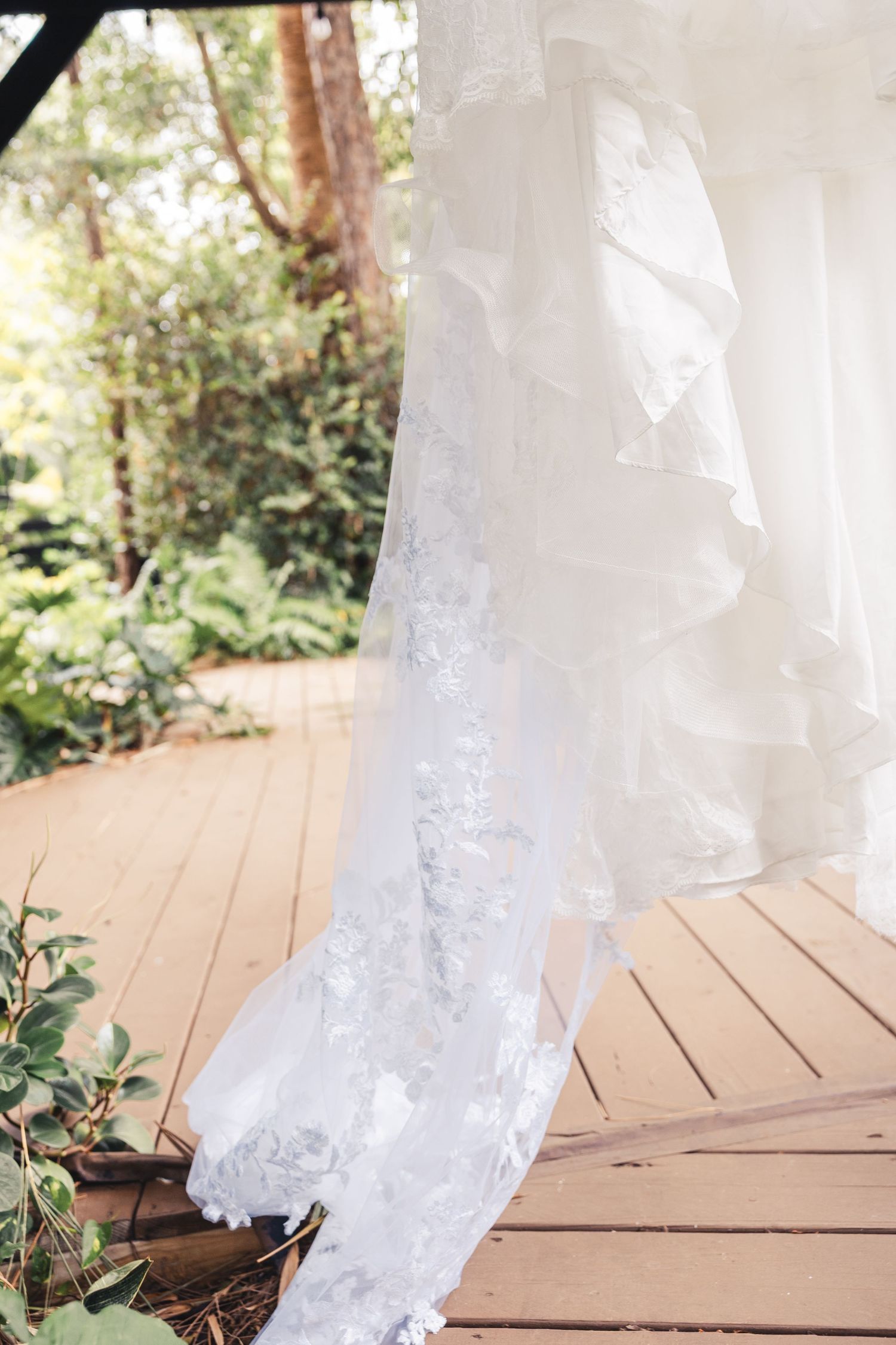 Wedding dress and veil detail on porch at Palm Beach Gardens wedding
