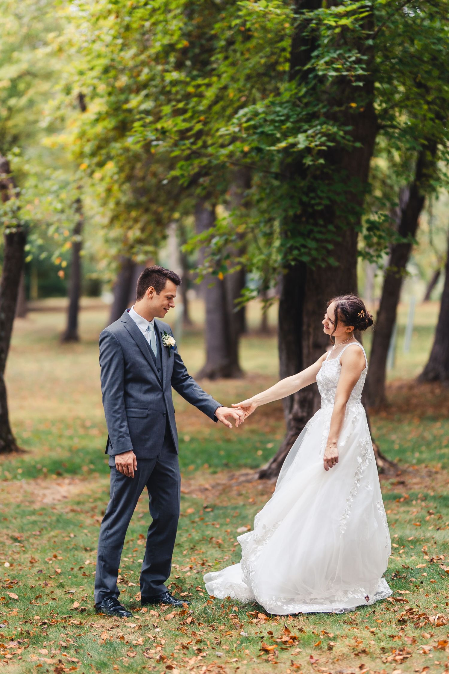Bride and groom holding hands during outdoor wedding portrait in Palm Beach Gardens