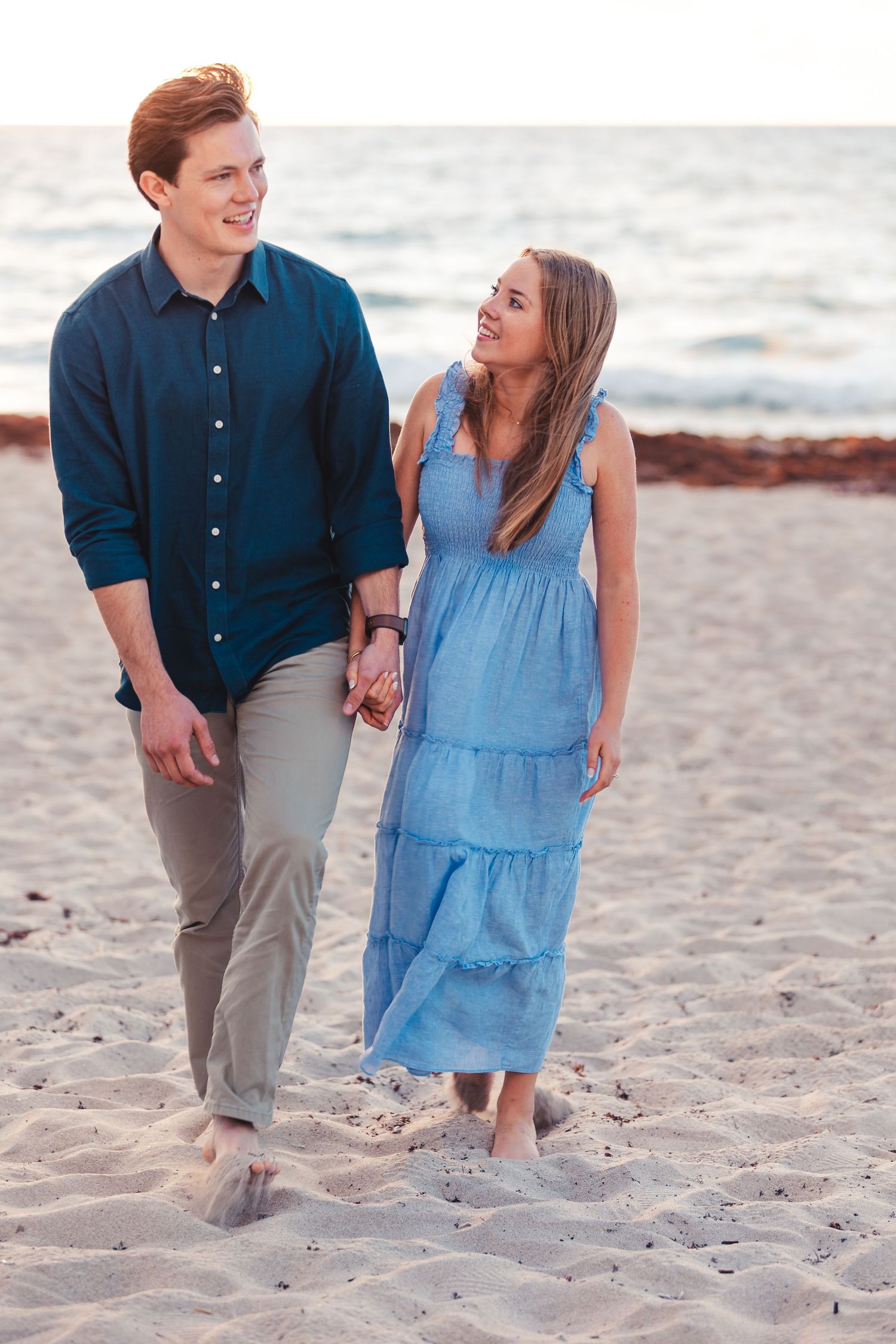 Couple smiling together on the beach during Palm Beach Gardens engagement session