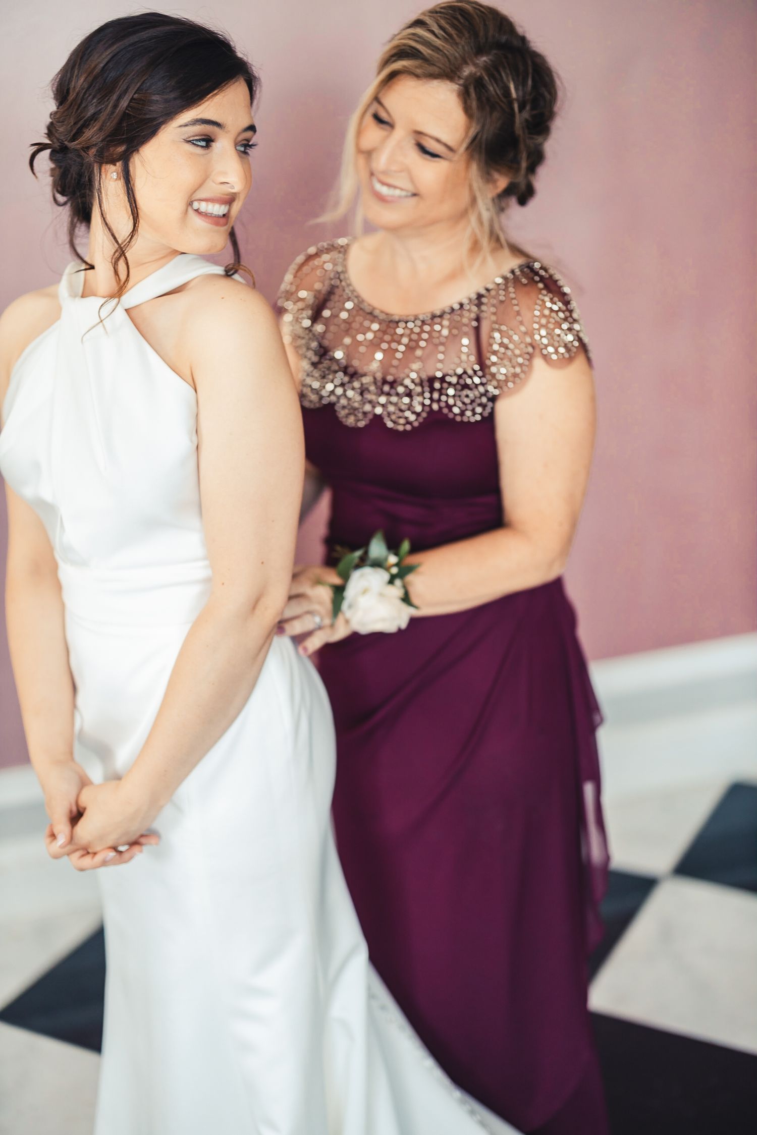 Bridesmaid helping bride get ready before ceremony in West Palm Beach FL