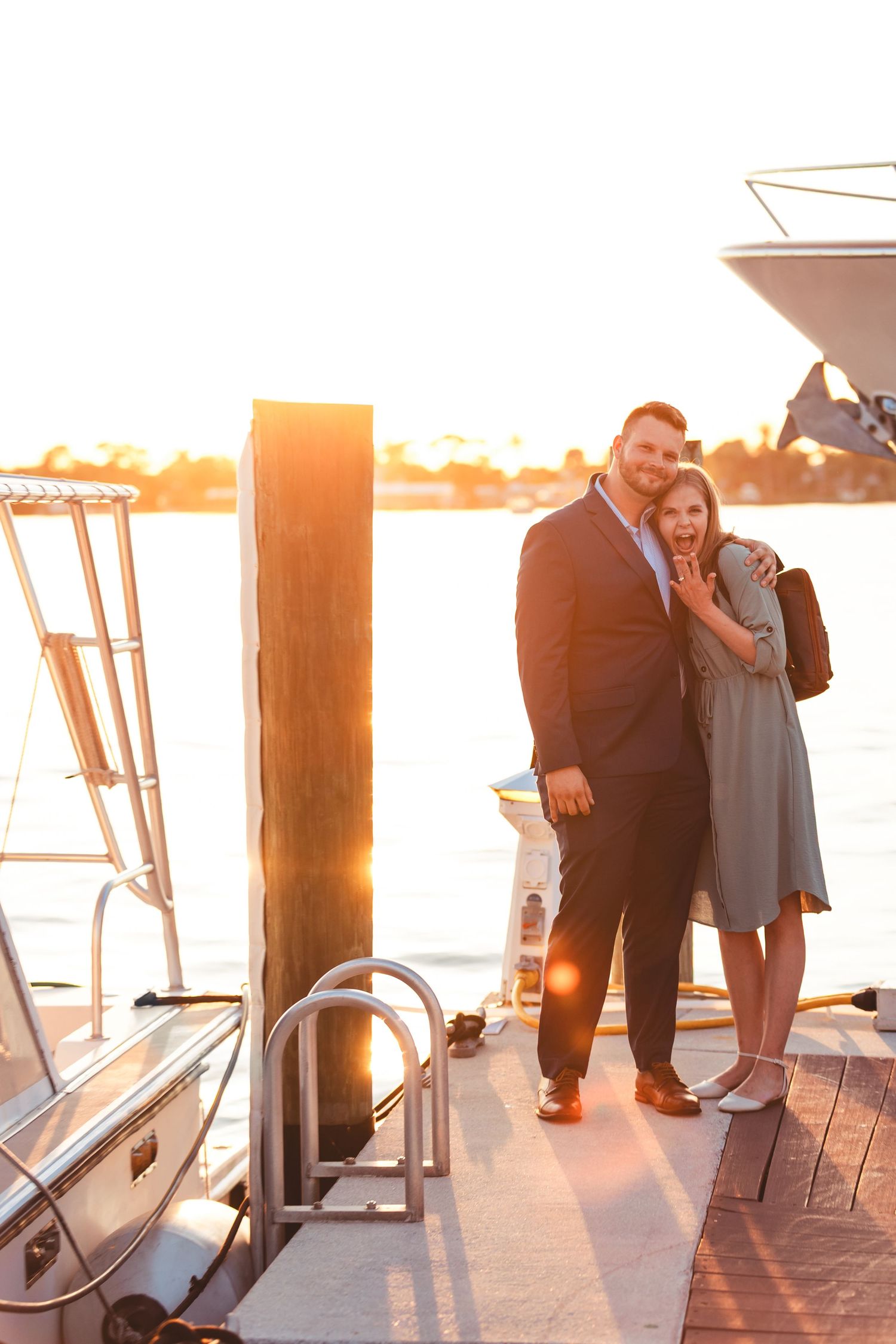 Couple hugging by the water at sunset during West Palm Beach Florida engagement session