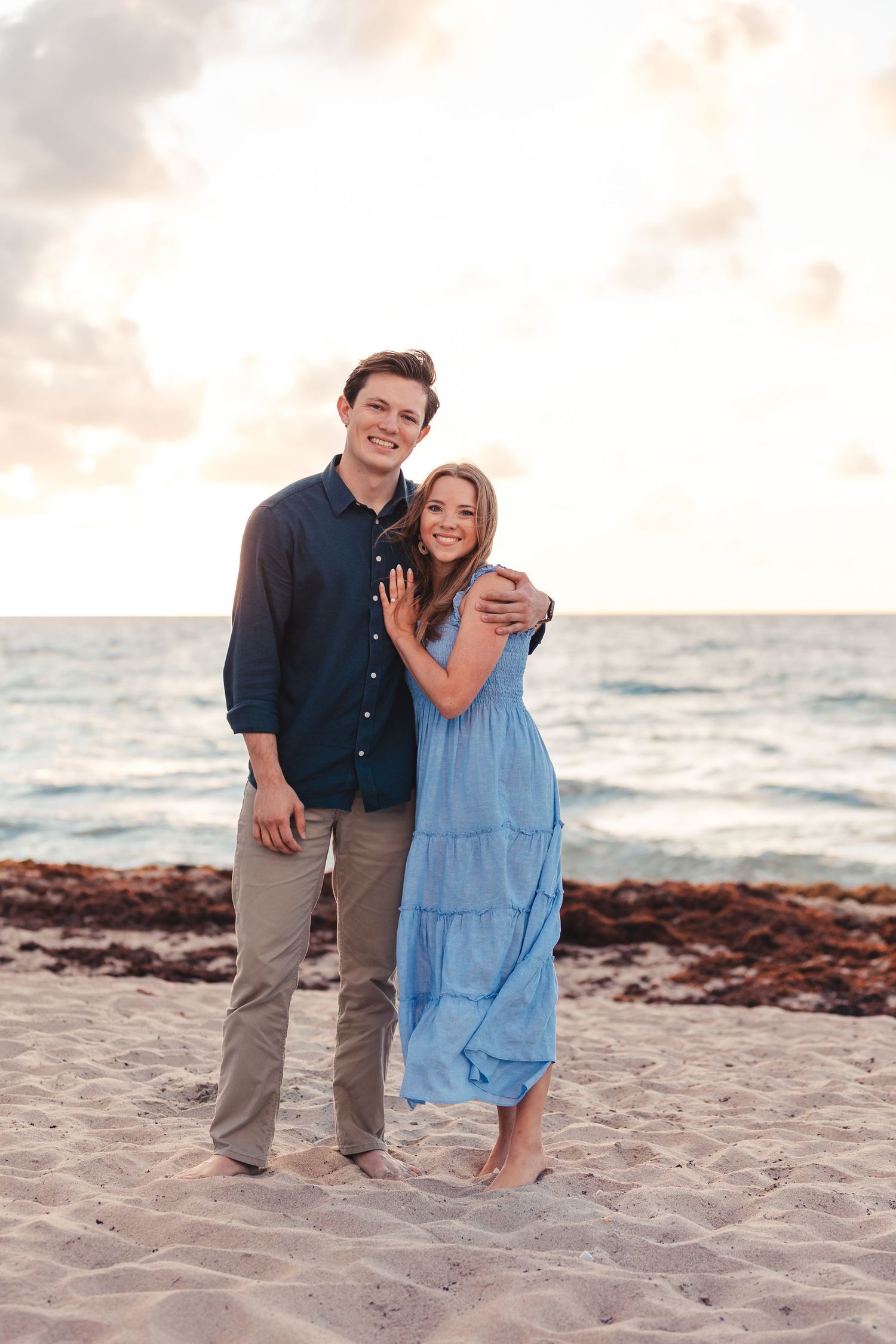 Couple smiling together on the beach during Palm Beach Florida engagement session