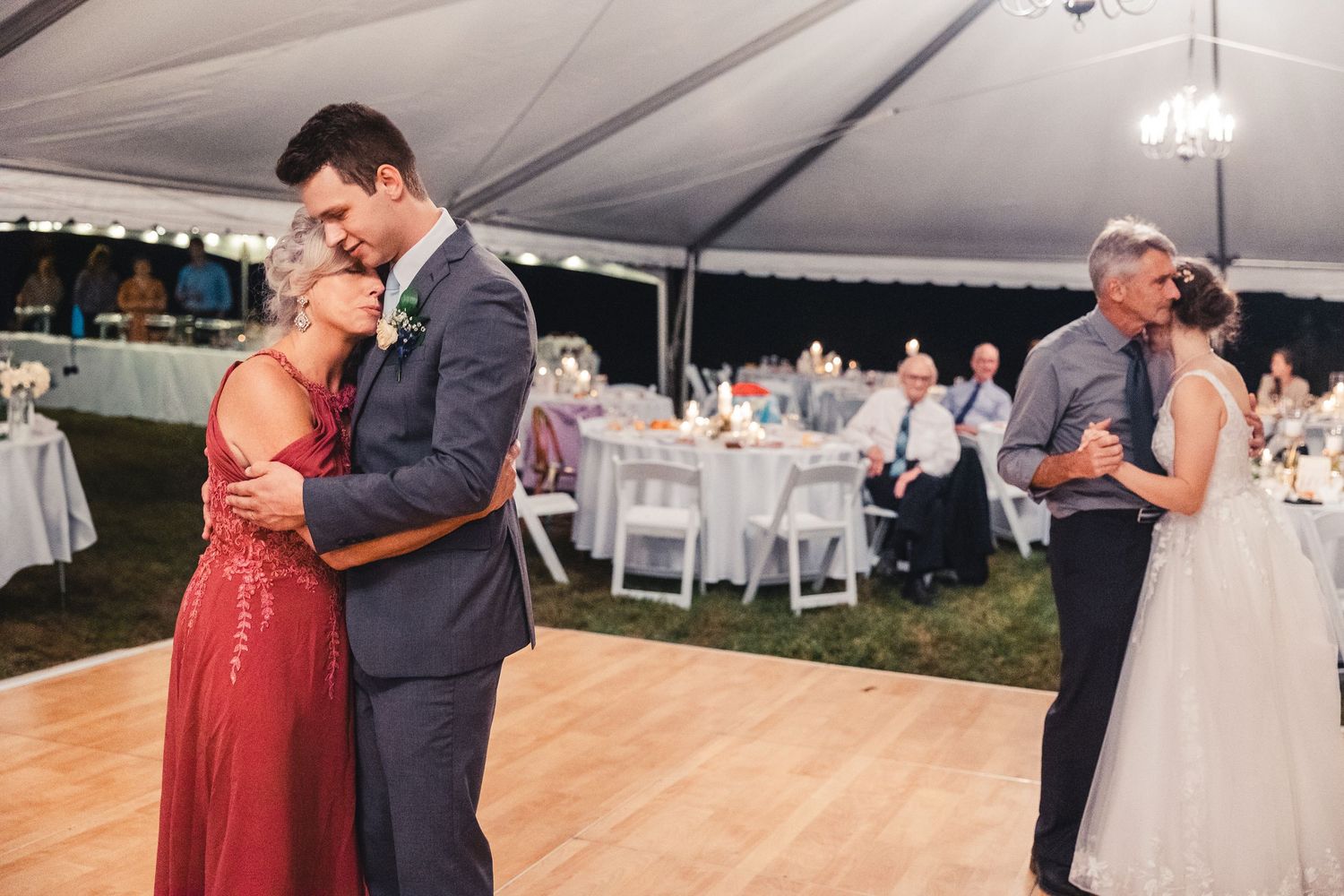 Groom hugging mother during emotional wedding reception dance in Palm Beach Gardens