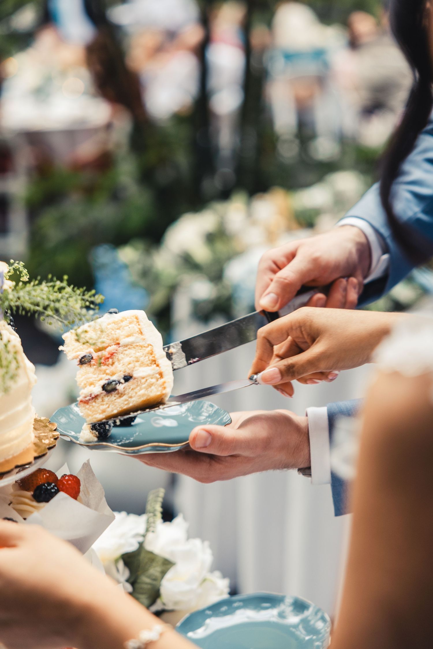Bride and groom serving cake during wedding reception in Palm Beach Gardens