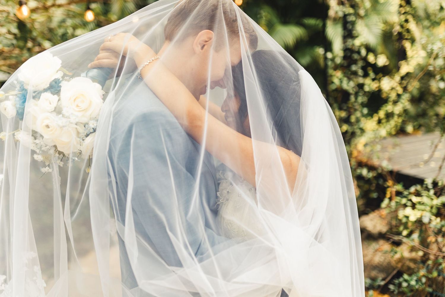 Bride and groom under veil during romantic wedding portrait in Palm Beach Gardens