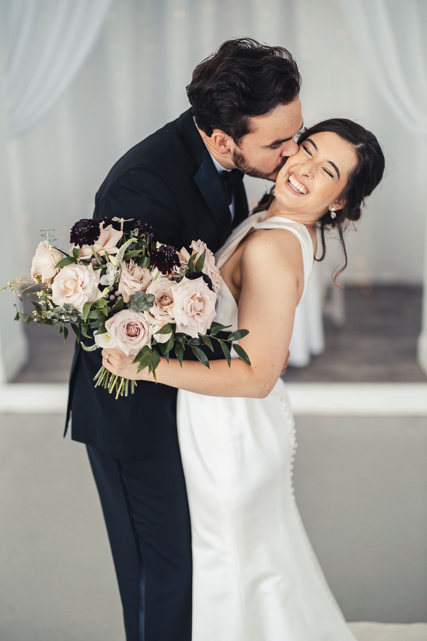 Groom kissing bride during classic wedding portrait in Palm Beach Gardens