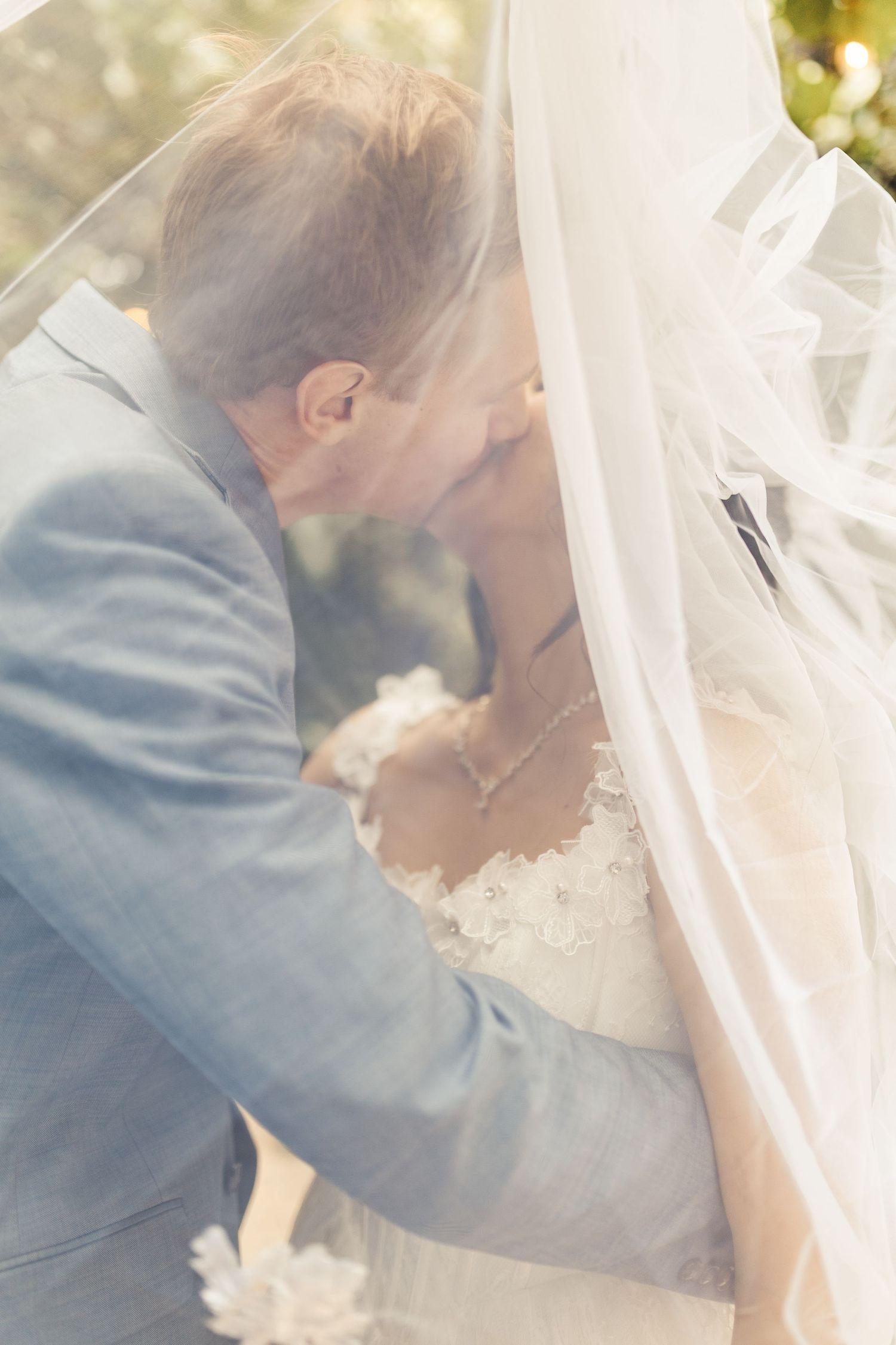 Bride and groom under veil during intimate wedding portrait in Palm Beach Gardens