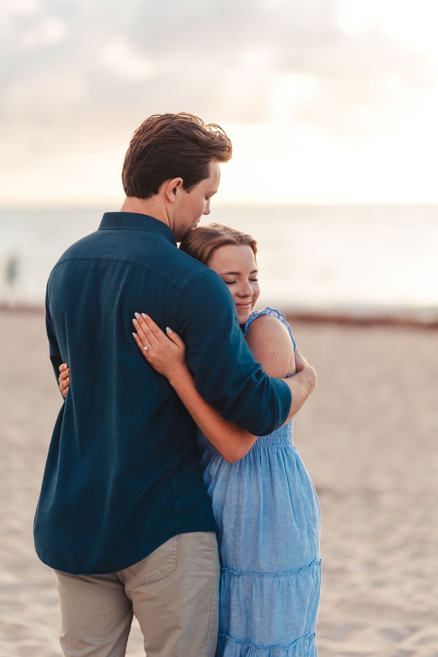Couple embracing on the beach during Palm Beach Gardens engagement session
