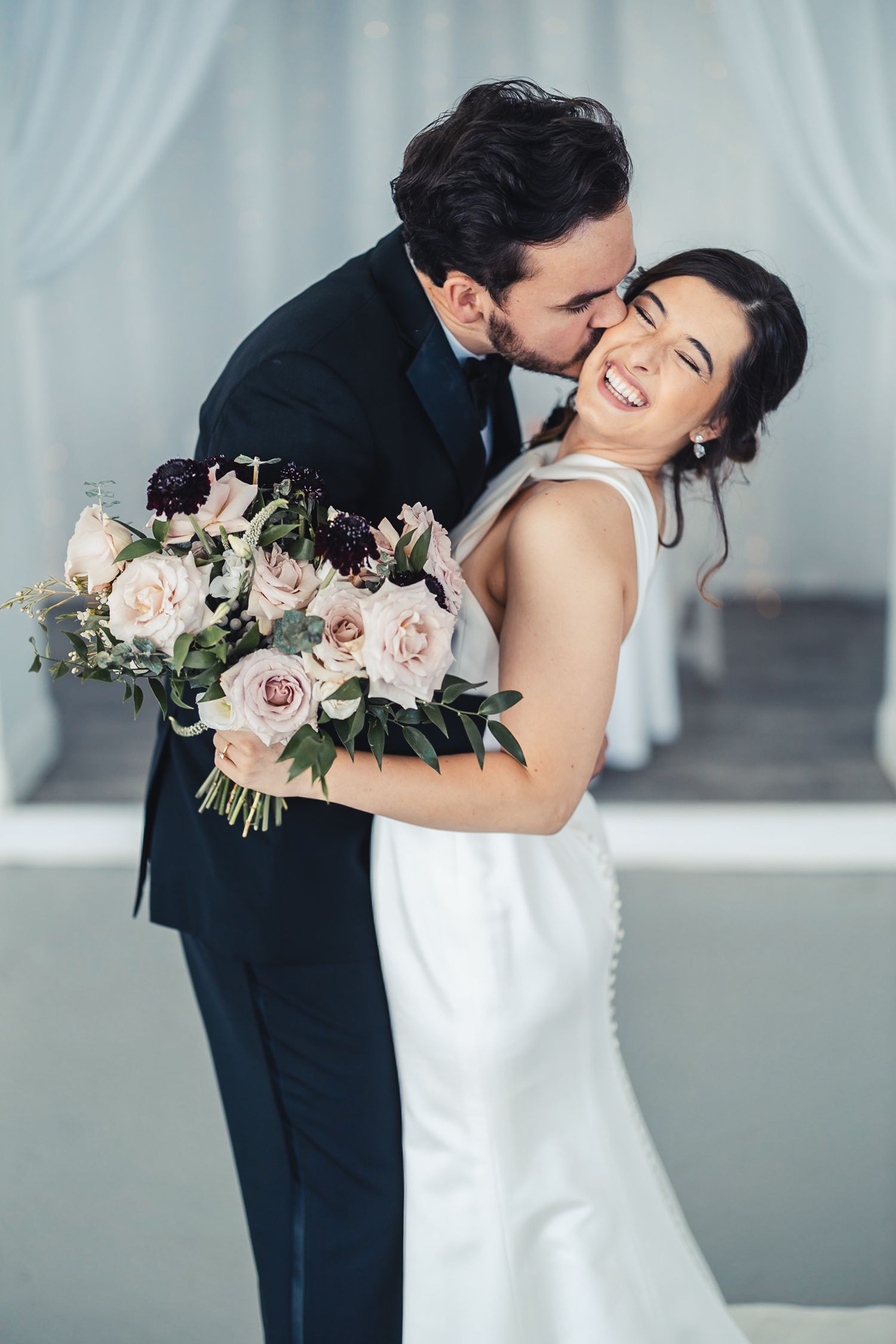 Groom kissing bride during romantic wedding portrait in West Palm Beach FL