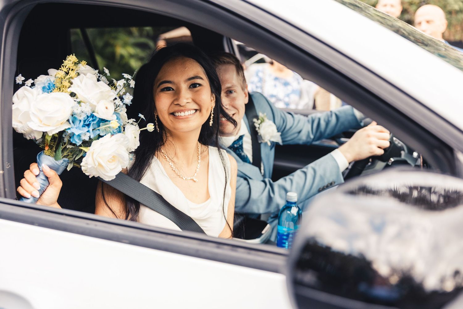Bride and groom smiling in getaway car after Palm Beach Gardens wedding