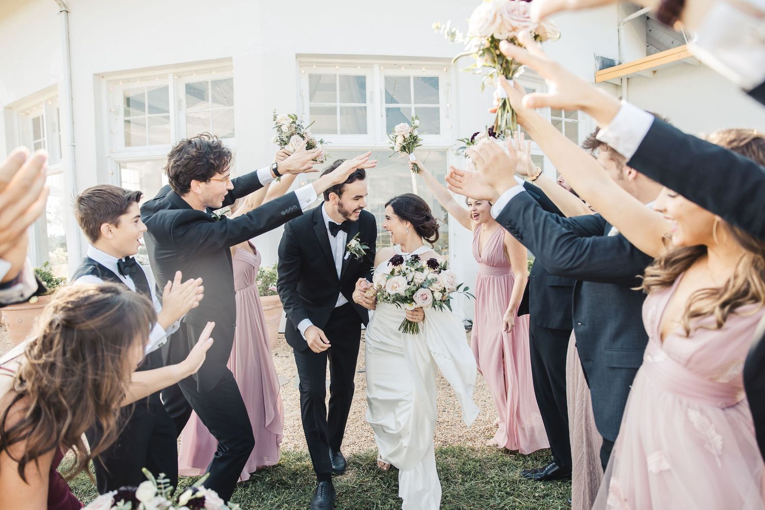Bride and groom walking through wedding exit celebration in Palm Beach Gardens