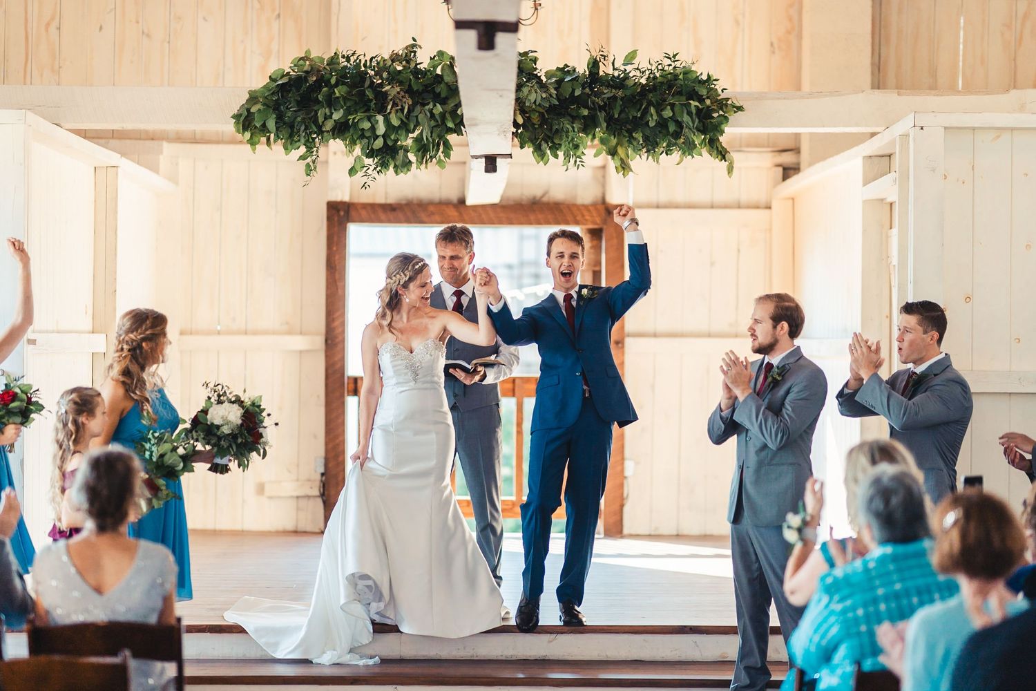 Bride and groom celebrating ceremony exit at Palm Beach Gardens wedding