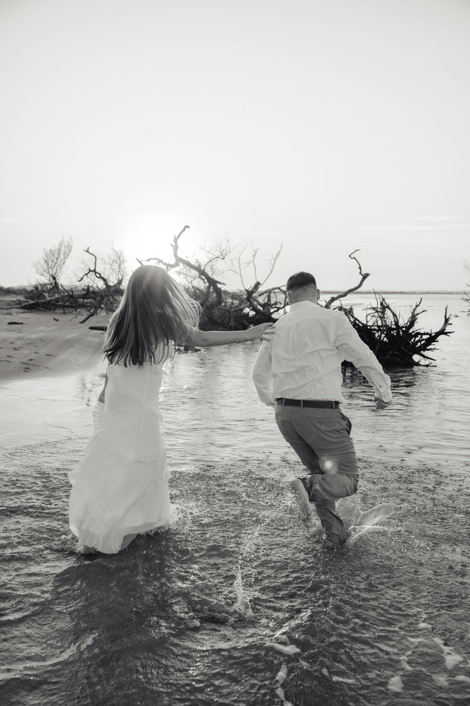 Candid lifestyle couple portraits on the beach at Folly Beach with soft coastal light