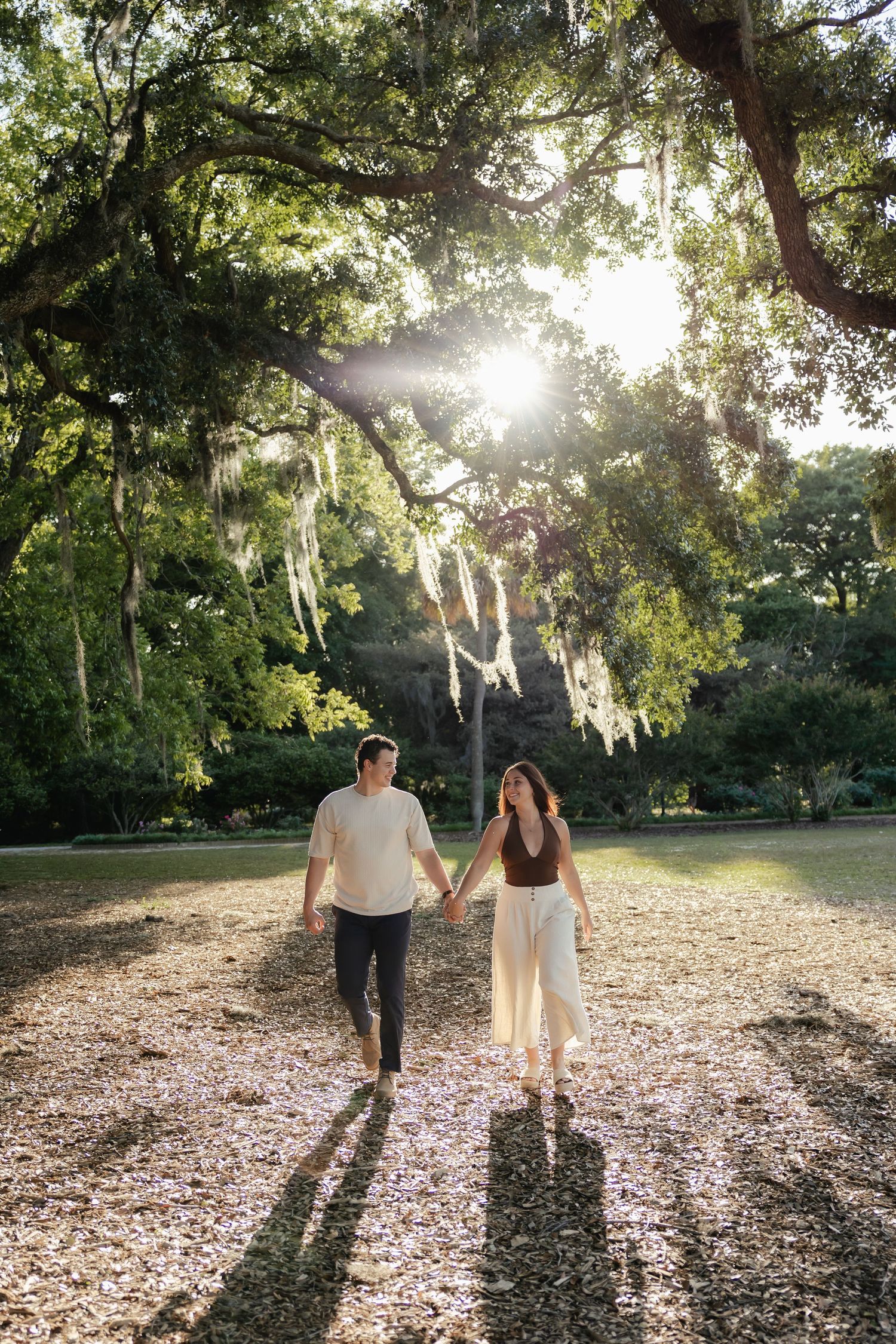 Golden hour proposal moment in Hampton Park with joyful reaction and romantic scenery