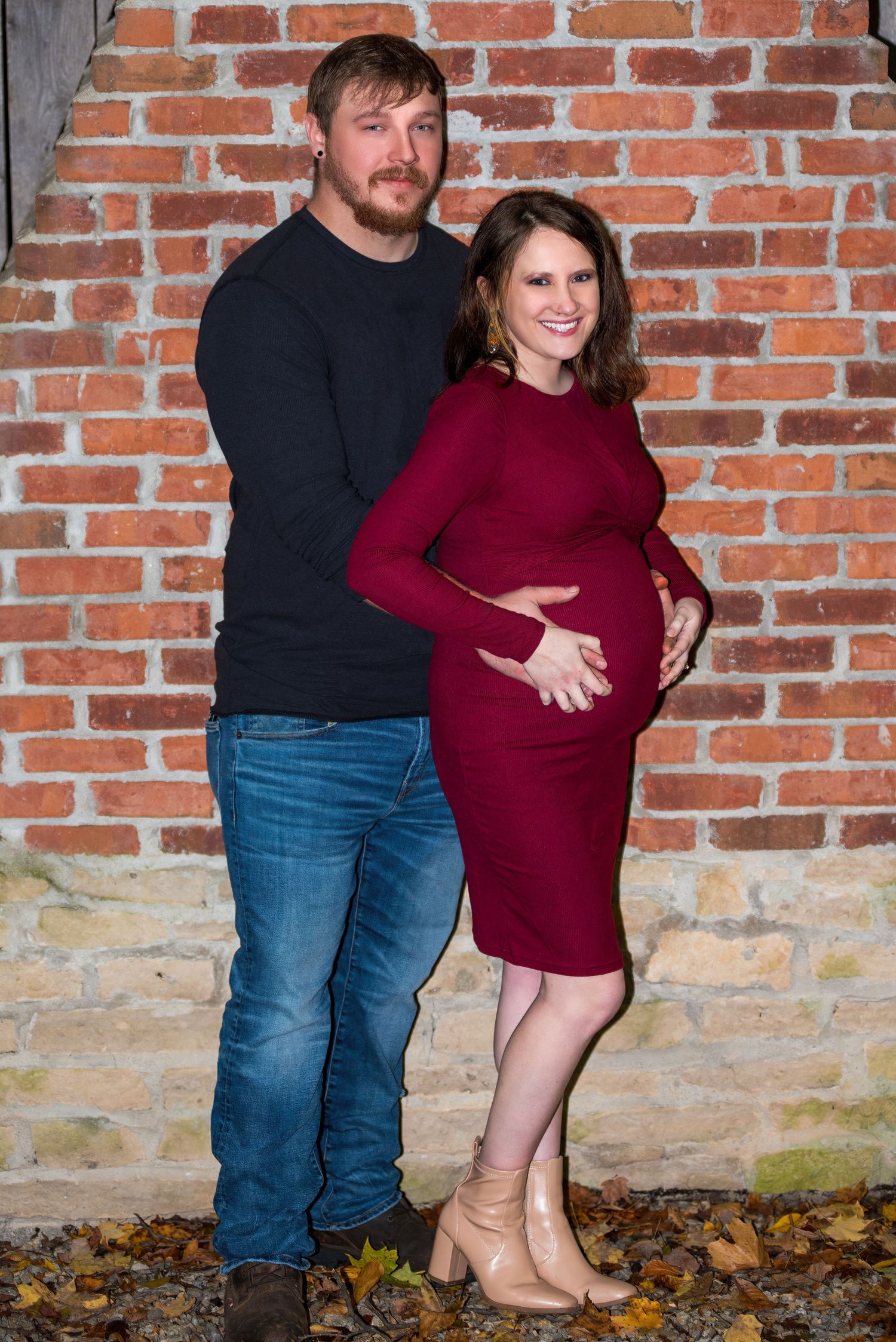 Family photos against rustic brick wall backdrop in casual attire.