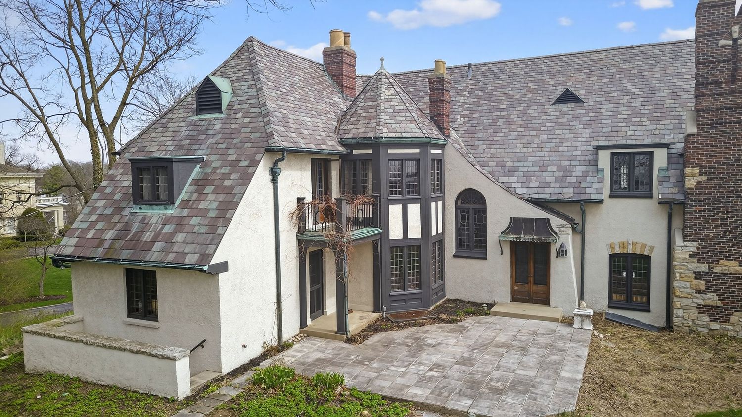 Panoramic collage of a modern home exterior showing multiple angles of the gray stone facade and architectural details.