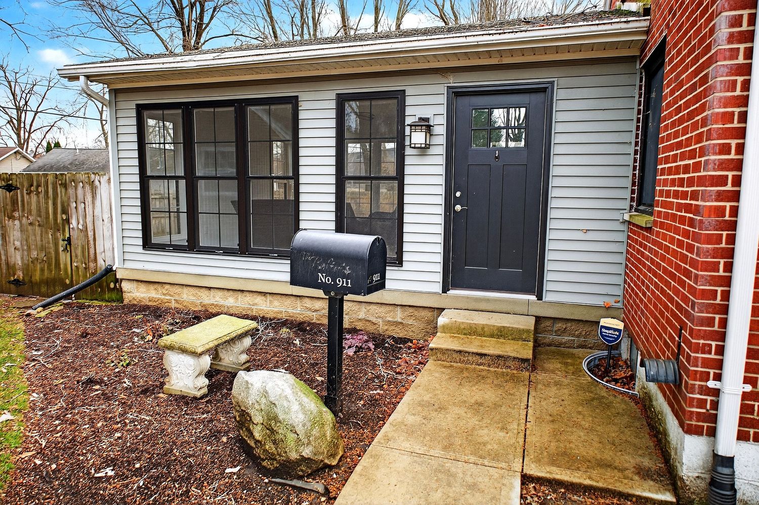 A collage of exterior home photos showing walkways, landscaping, and entryways of a residential property.