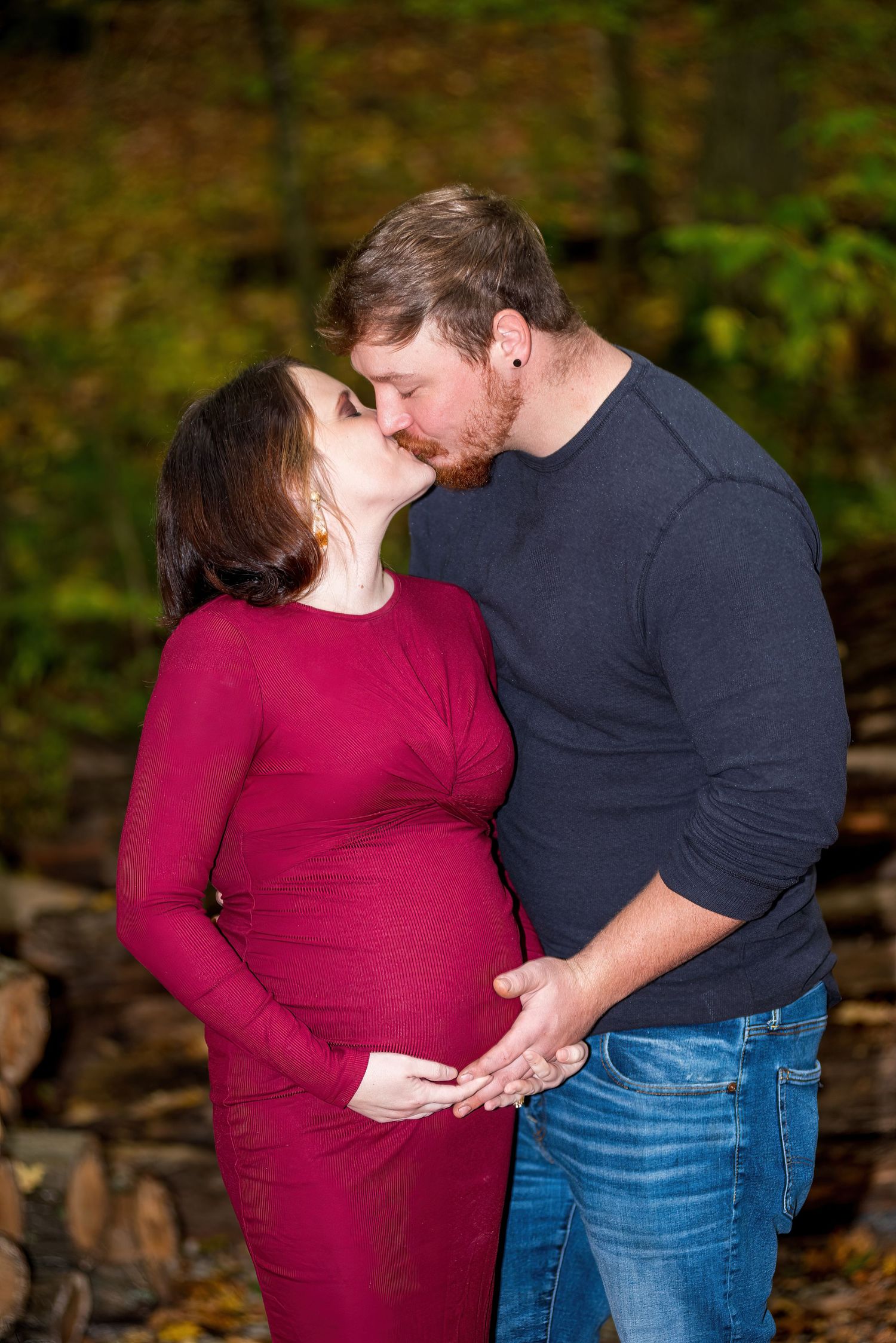 Intimate maternity photo session in a natural outdoor setting.