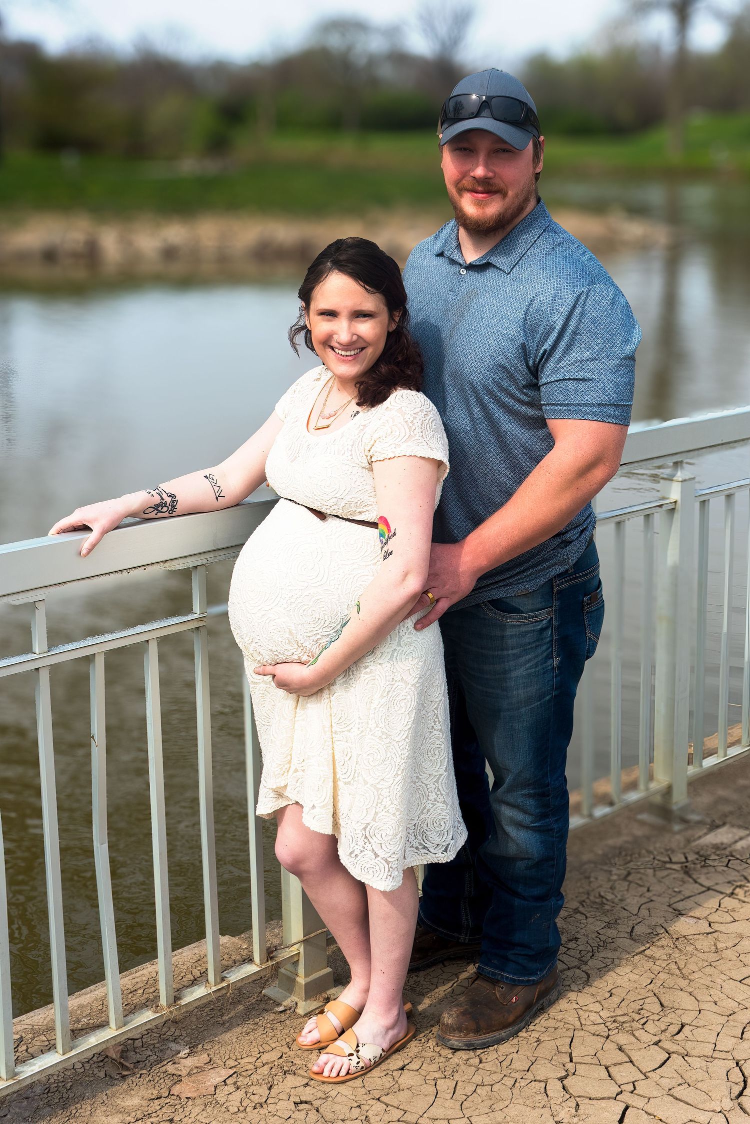 Romantic photo series on a lakeside deck with couple in casual attire.