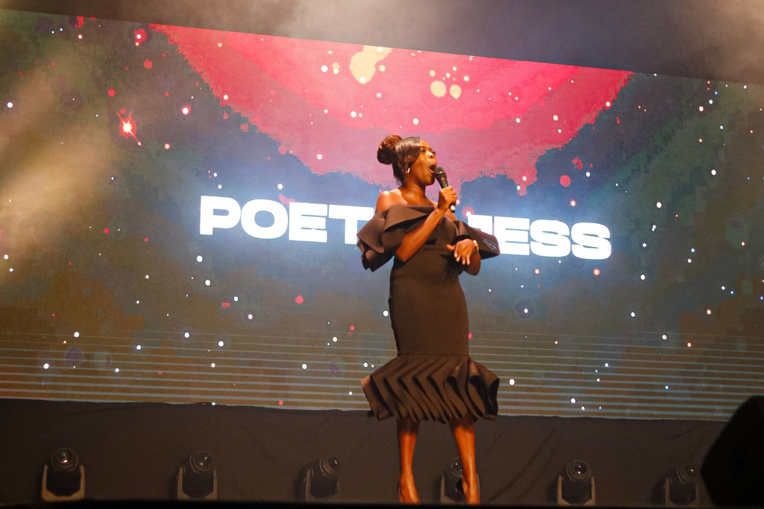 Stage performance with dramatic red lighting and special effects.
