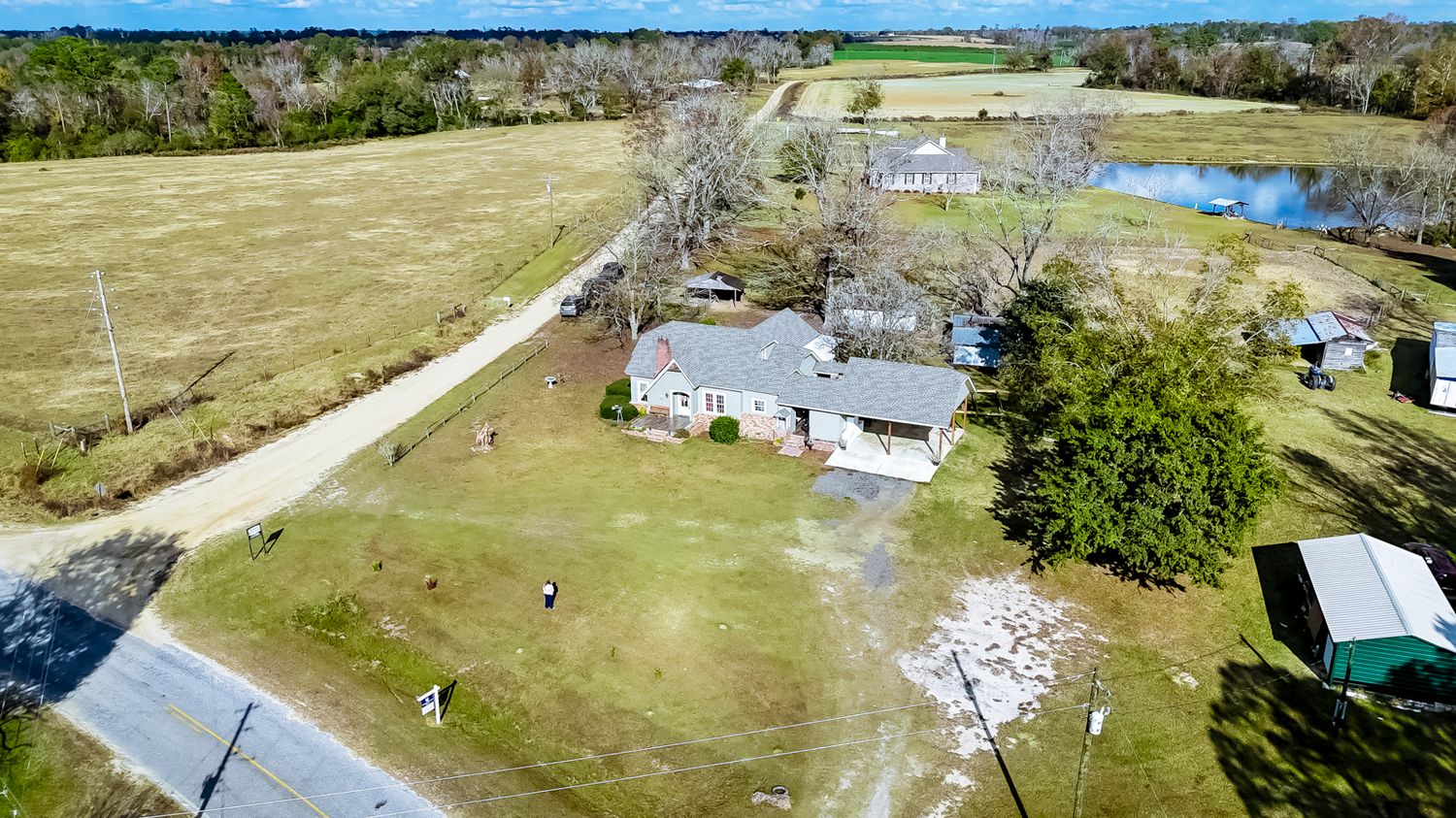 Panoramic aerial view of rural countryside with scattered houses and open fields.