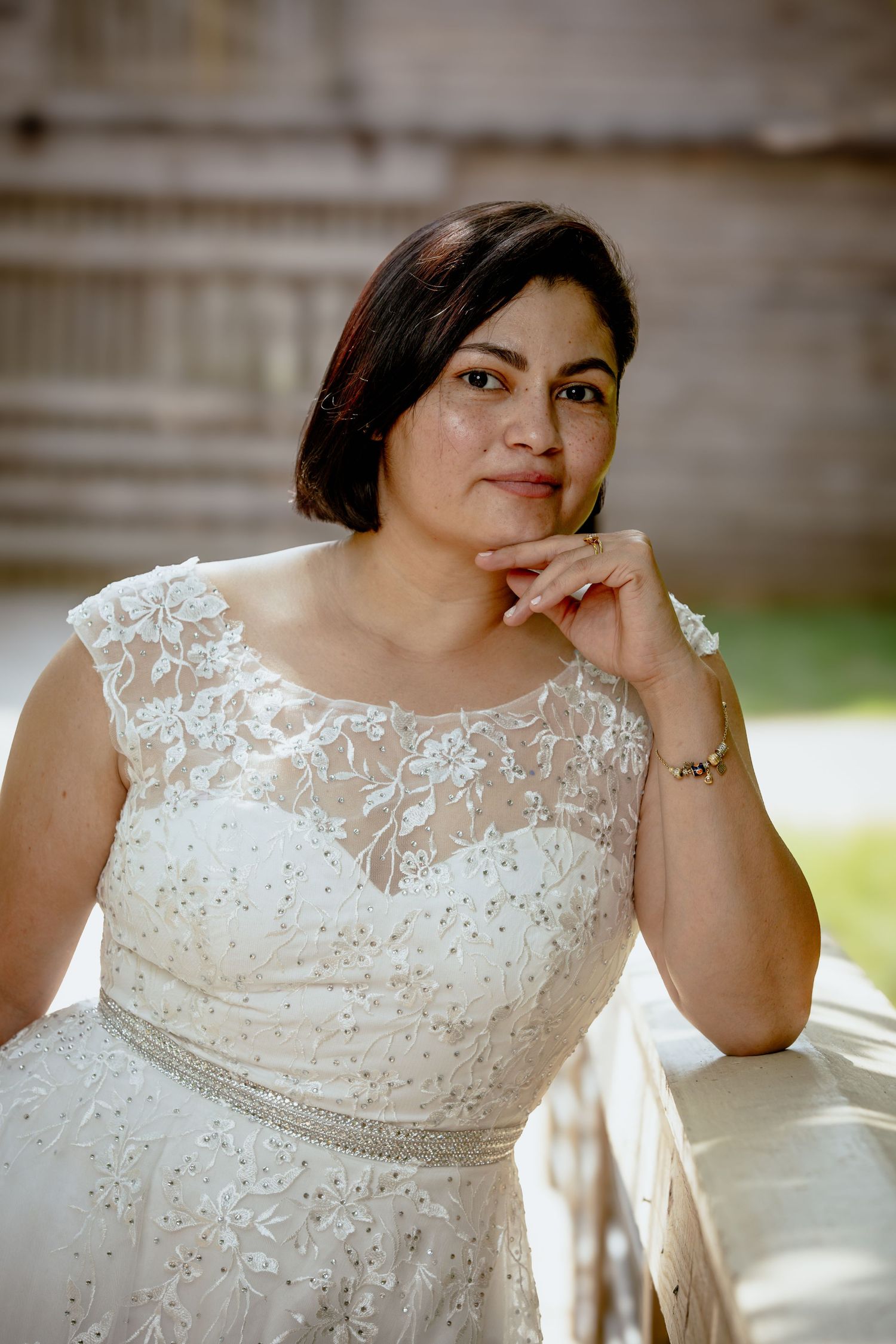 Close-up portrait shots of a bride in an elegant lace wedding gown.