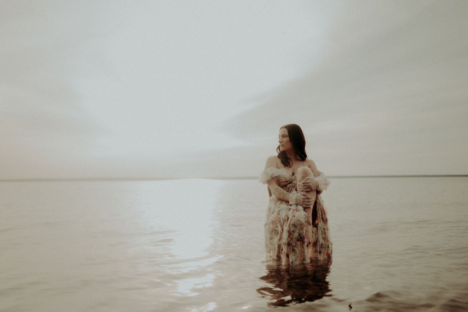 Sepia-toned water portrait series with ethereal lighting and movement.