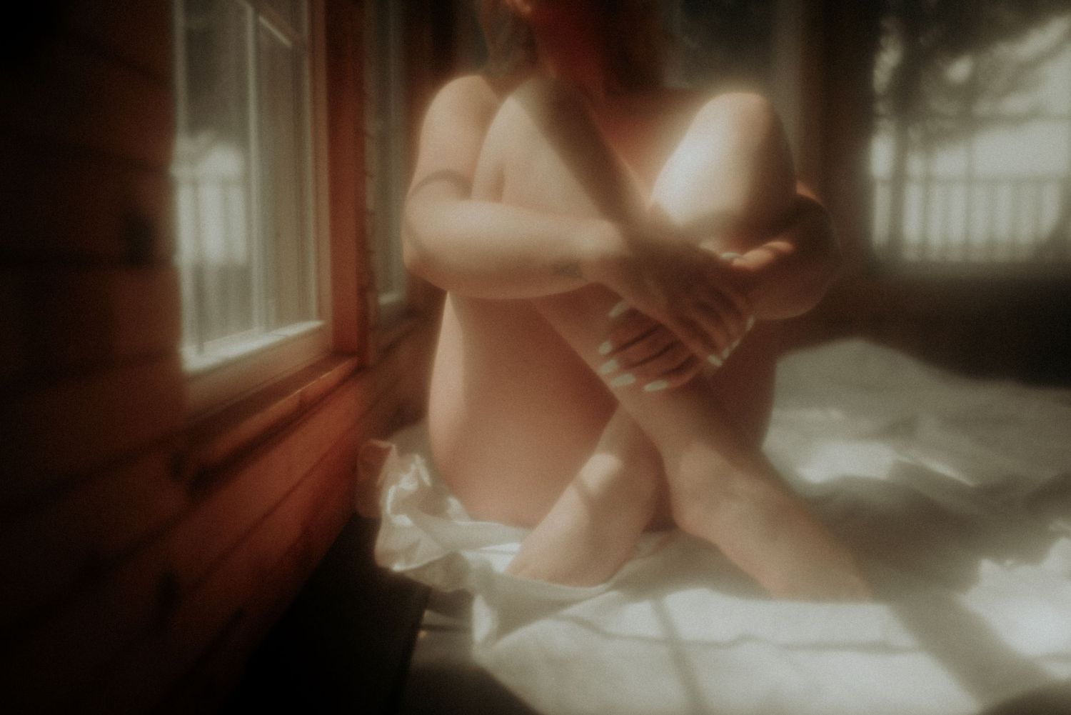 Artistic boudoir photo series with dreamy lighting and subtle movements.