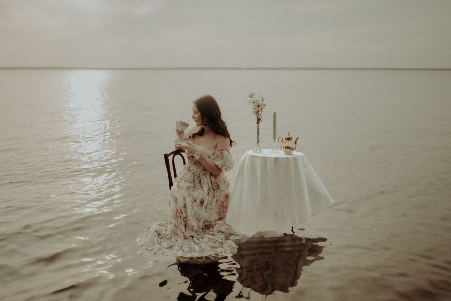 Artistic waterside scene with vintage styling and furniture partially submerged.