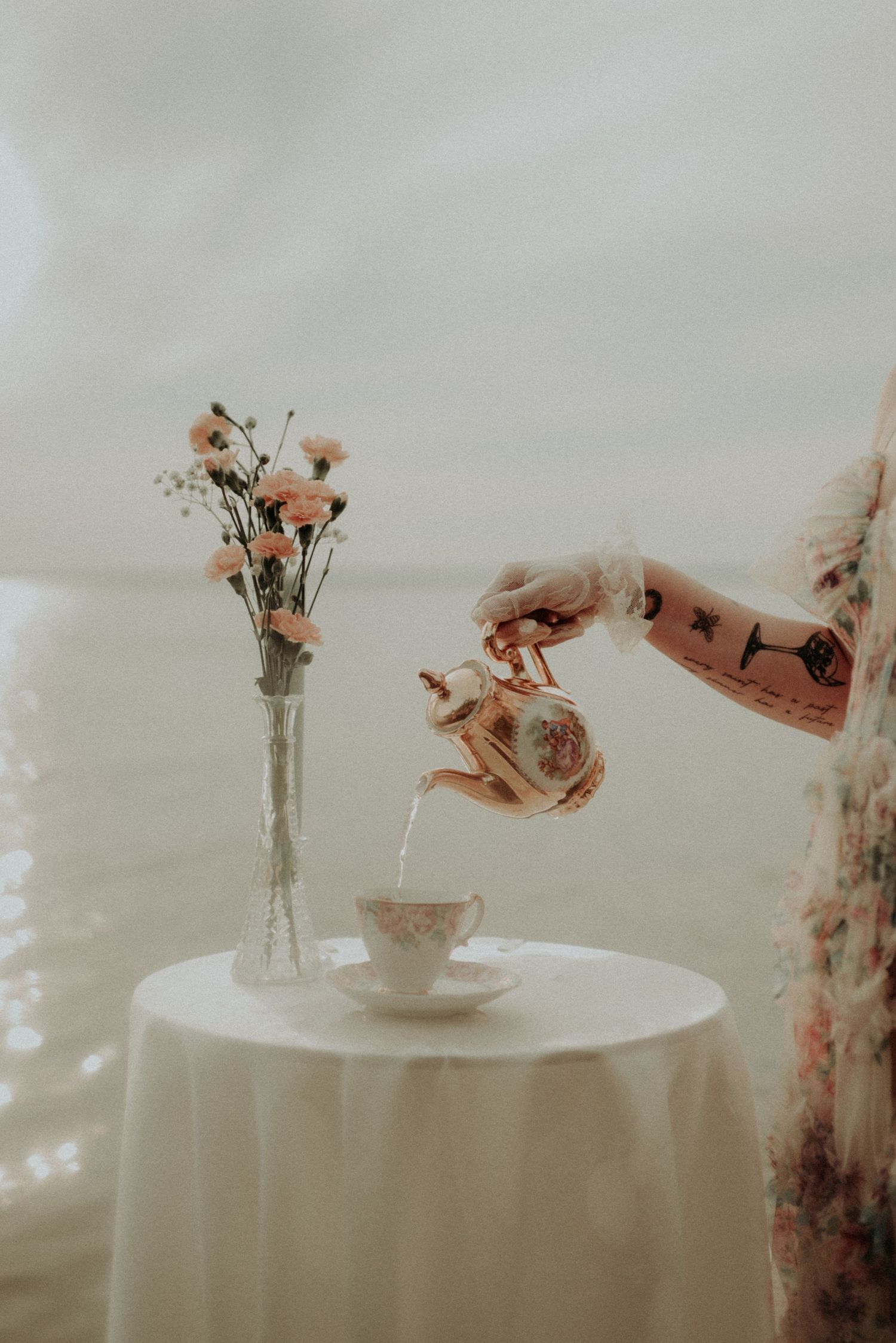 Close-up of delicate floral arrangements on white tablecloth with soft focus.