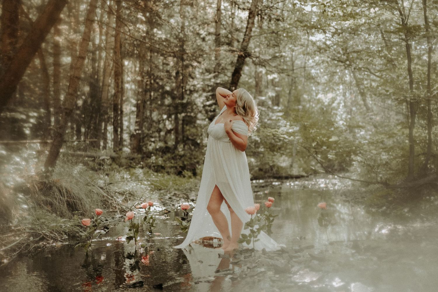 A romantic couple embraces in a misty forest setting during an ethereal outdoor photo session.
