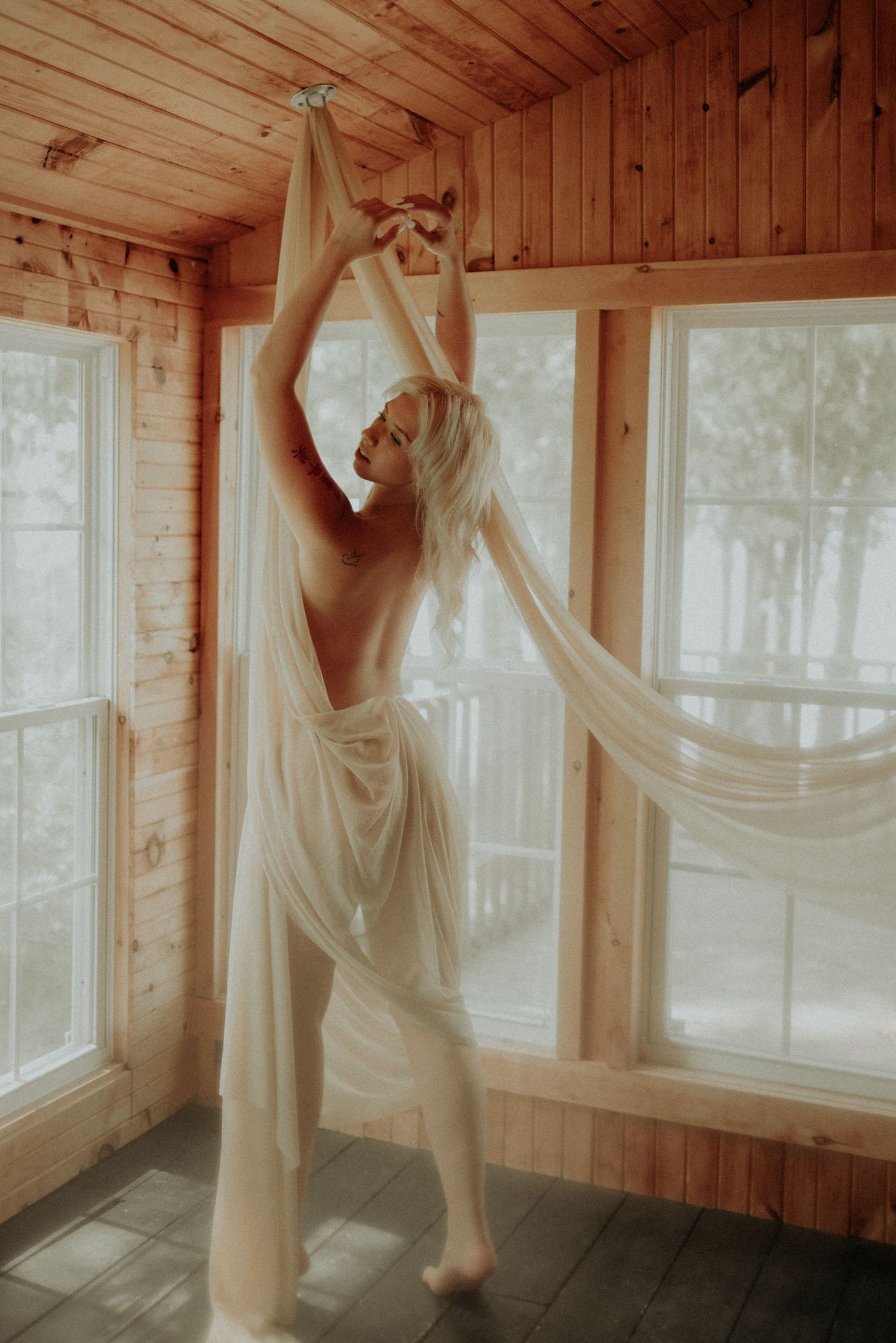 Sunlit dance-like movements captured against wooden panels and bright windows.