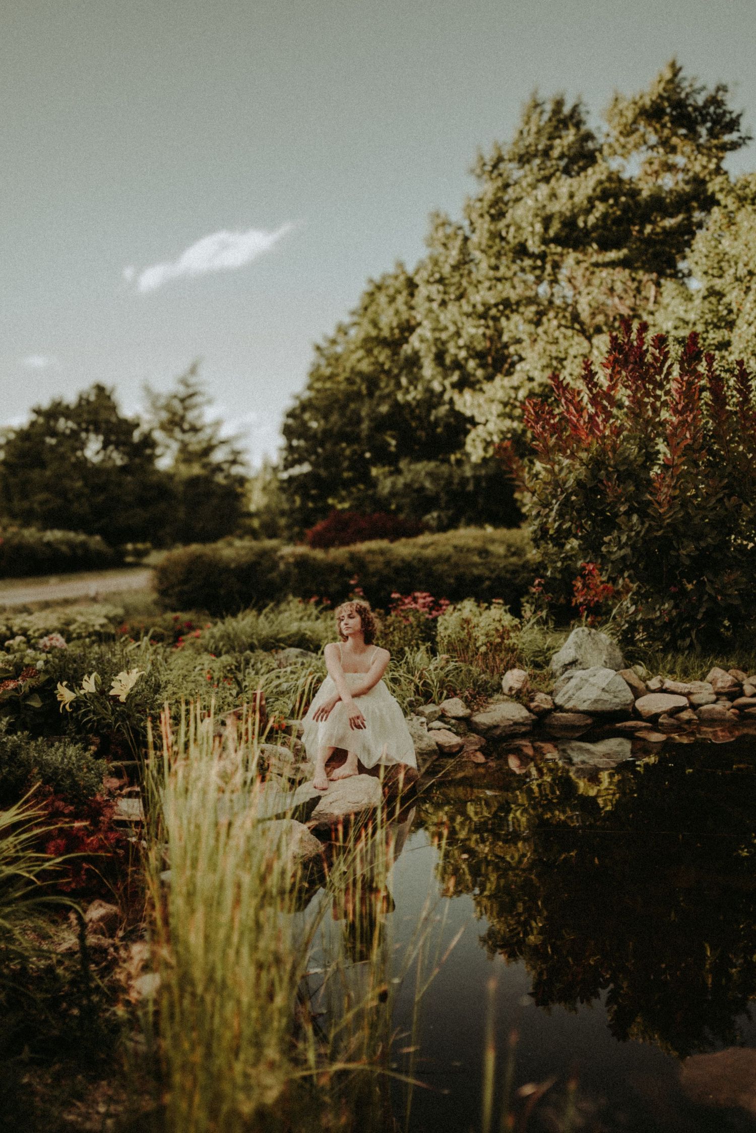 A dreamy sunset photoshoot in a garden with tall flowering plants and golden light.