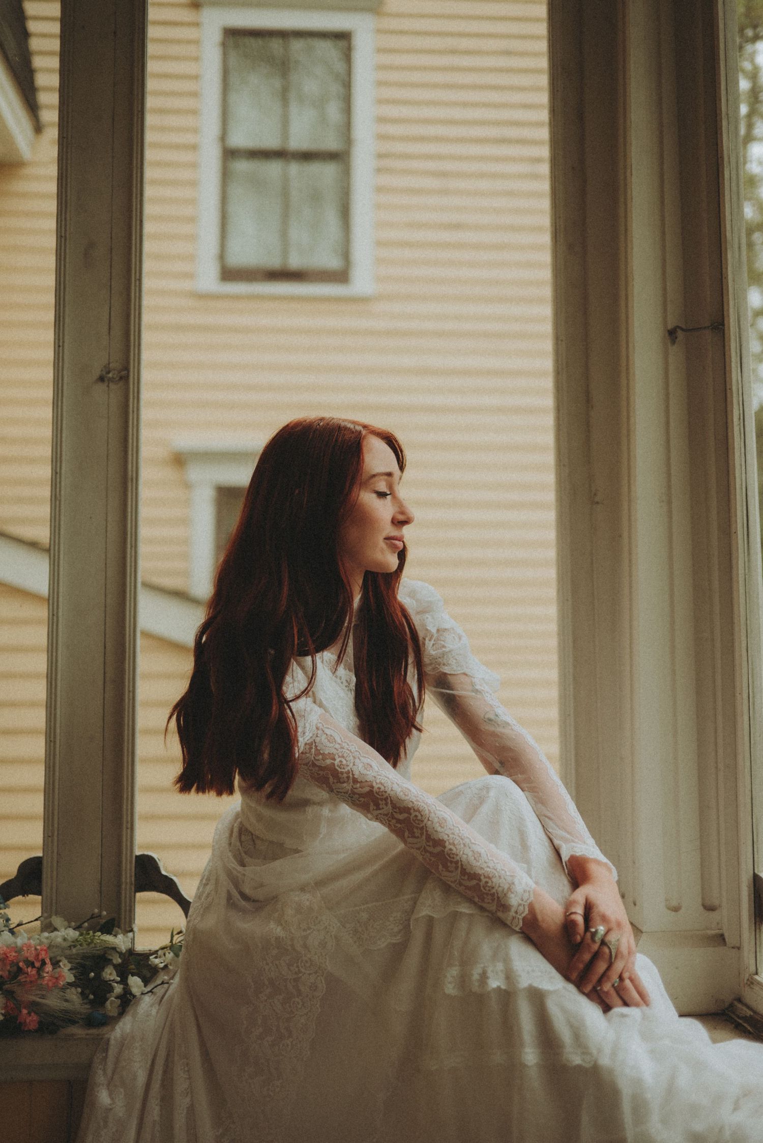 Candid bridal moments photographed in soft natural light on a vintage porch setting.