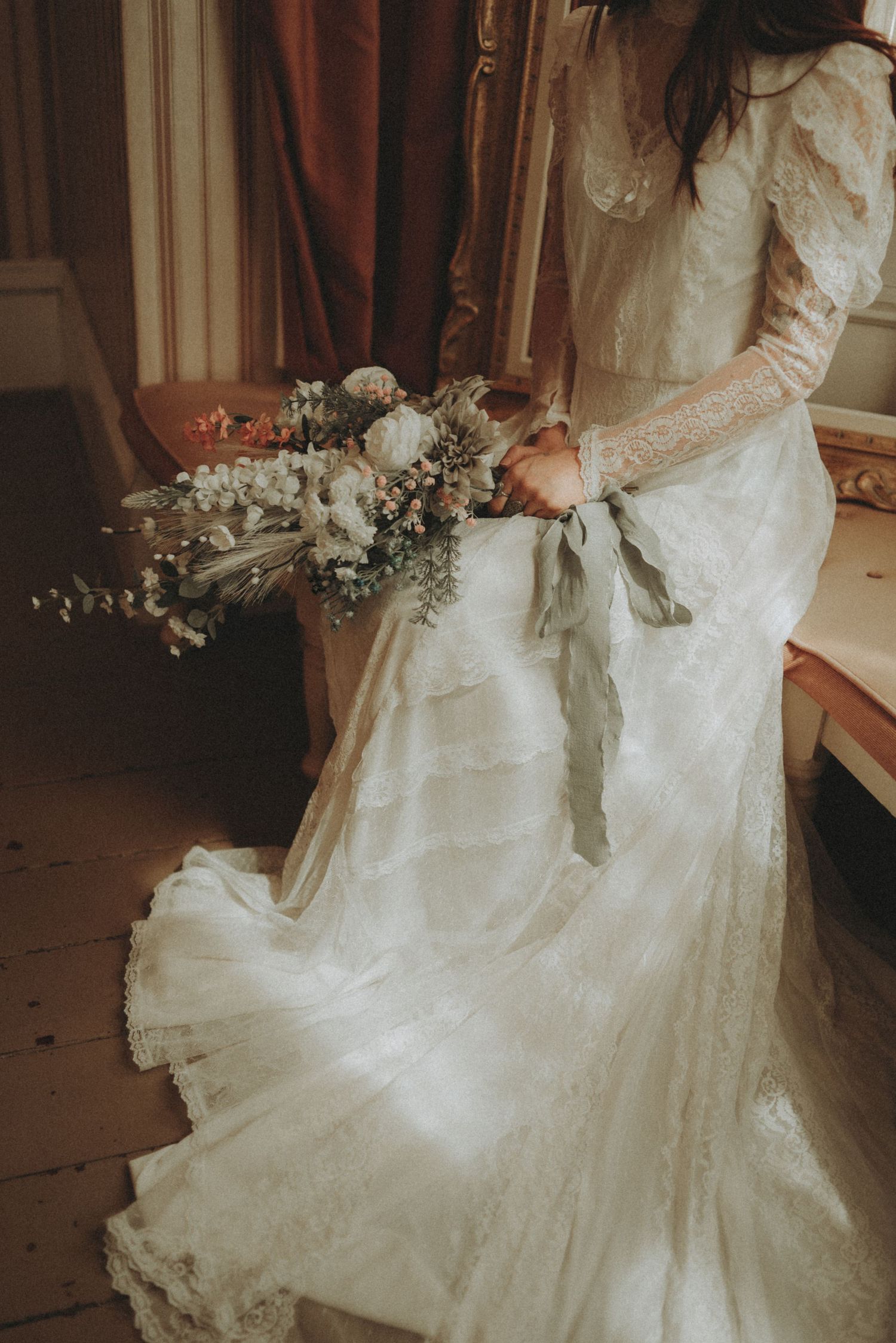 Dreamy wedding dress detail shots showing delicate lace and fabric against natural window lighting.