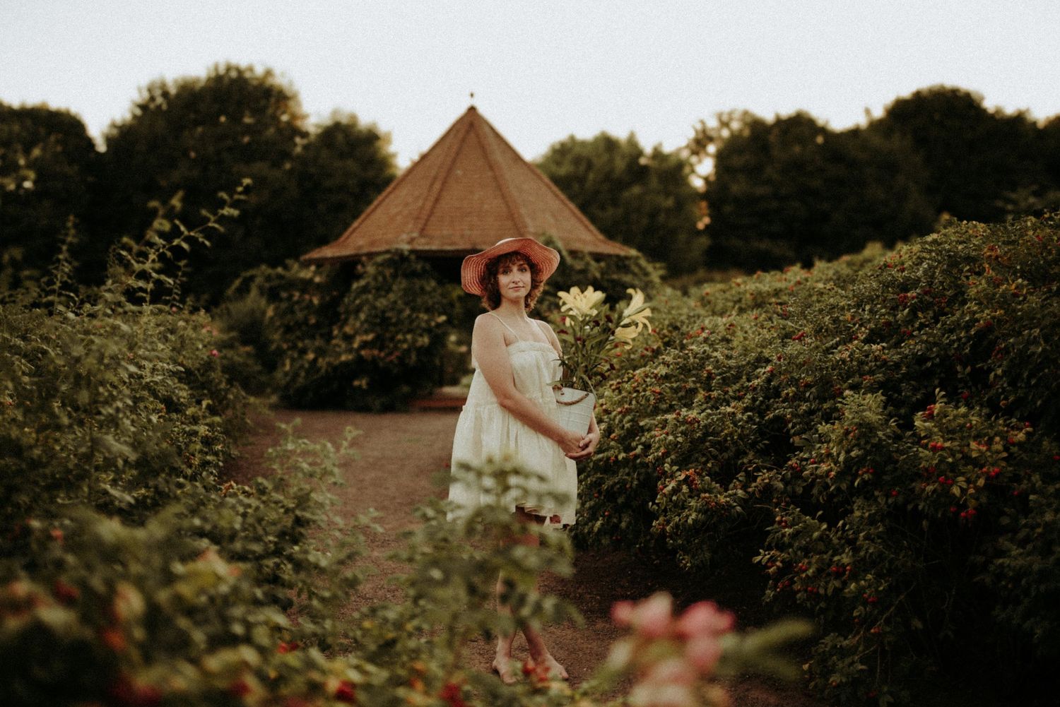 A golden-hour outdoor portrait session in a wildflower garden with soft natural lighting.