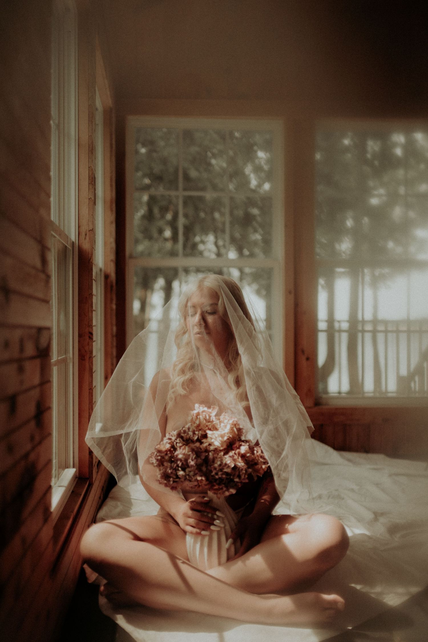 A dreamy boudoir photoshoot sequence shows a figure draped in white veil posing with flowers in soft window light.