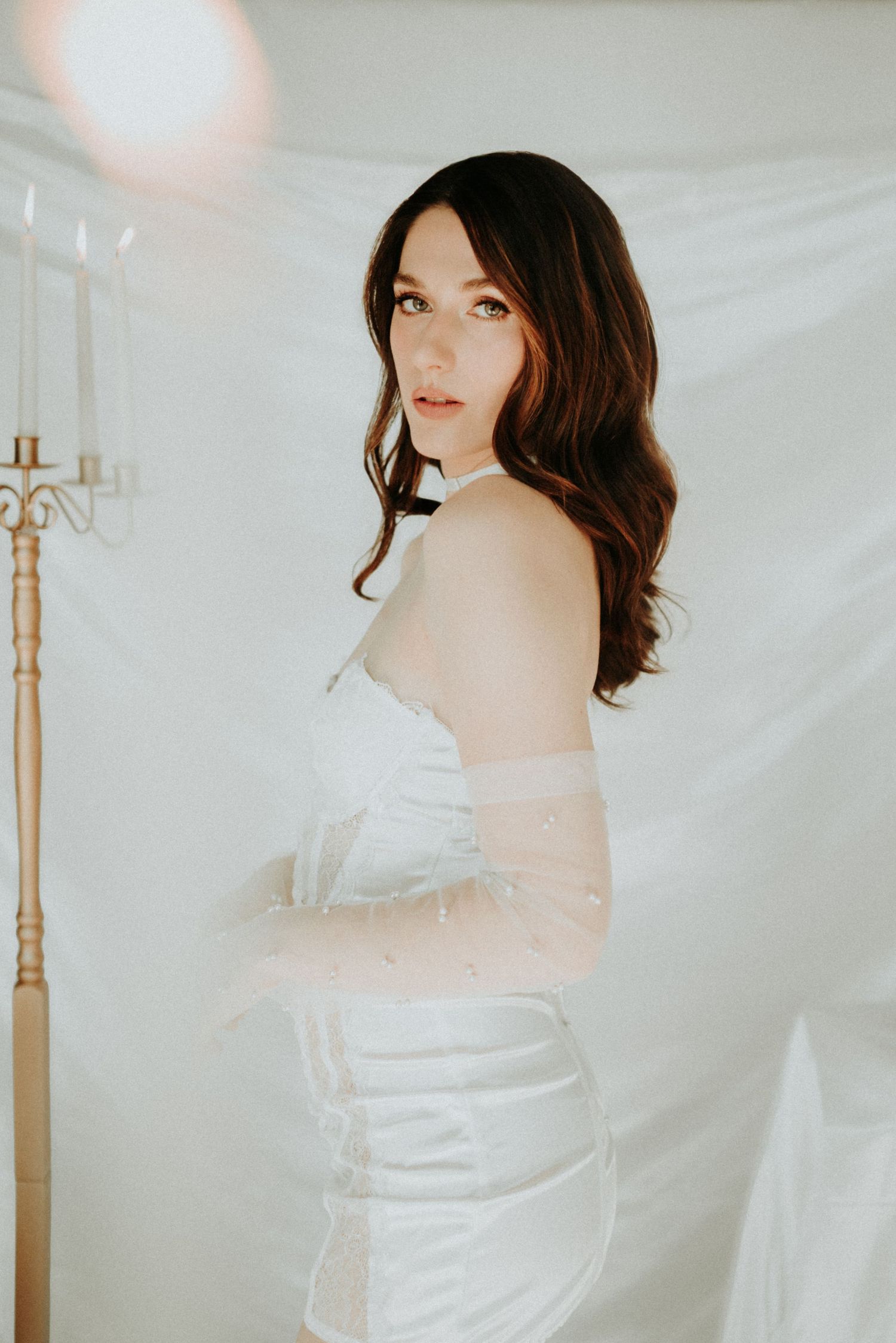 Ethereal portrait series against white fabric backdrop featuring soft lighting and romantic bridal aesthetic.