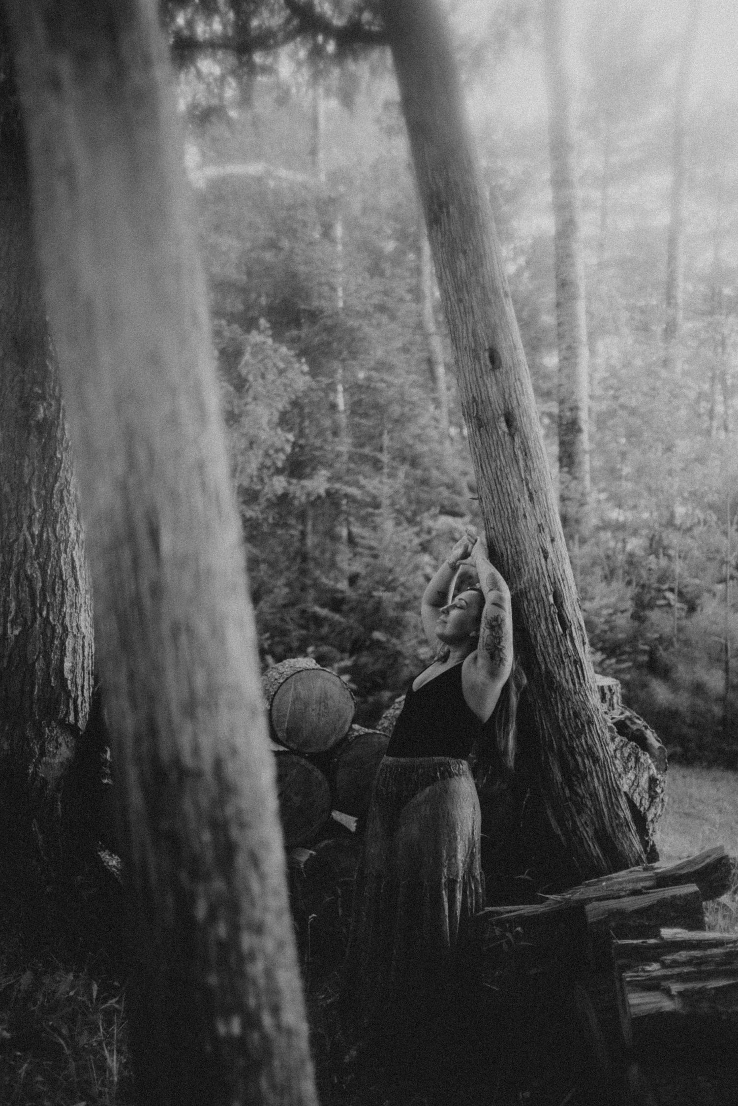 Artistic black and white forest photography with ethereal fabric movement.